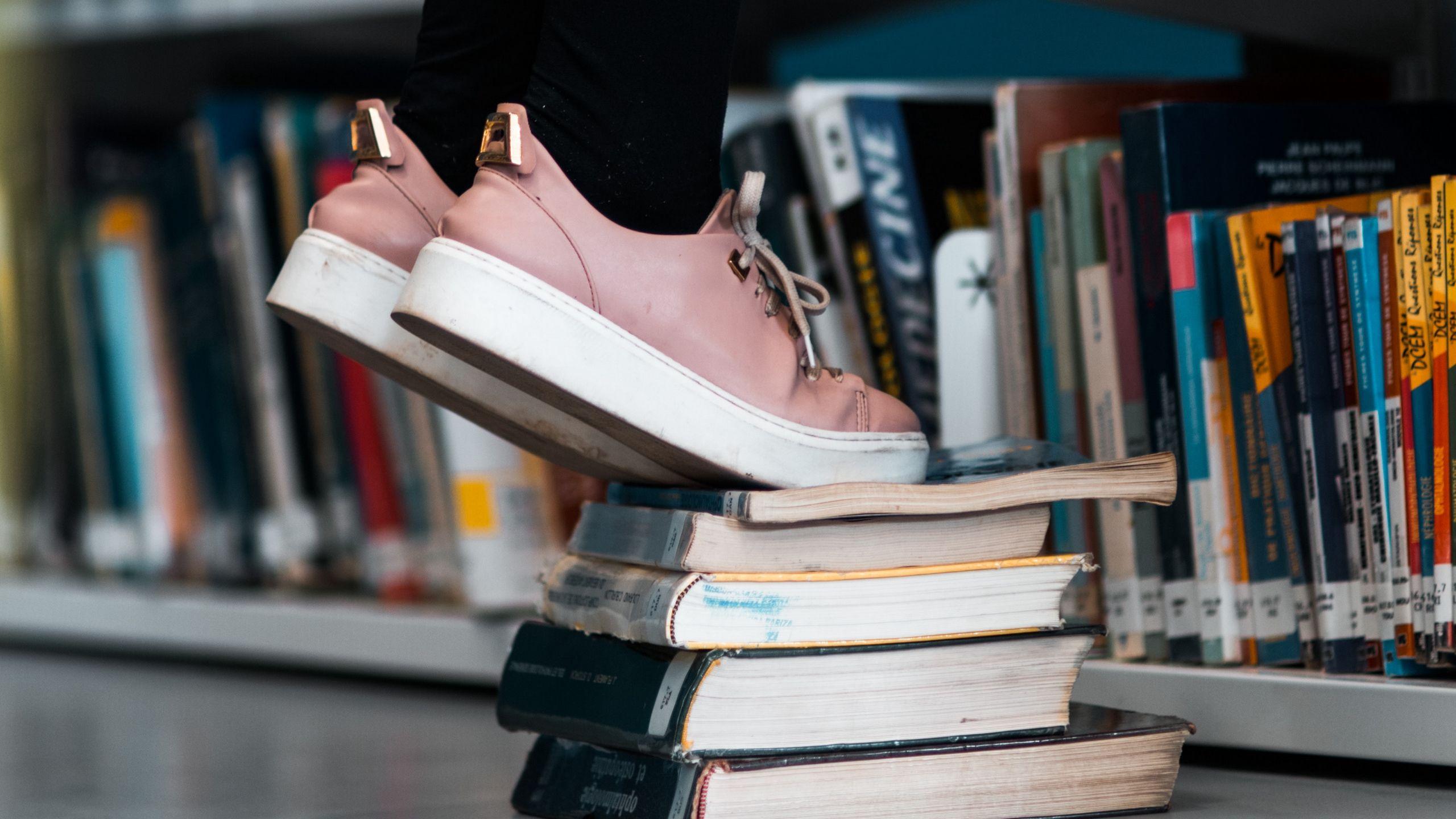 2560x1440 Download wallpaper 2560x1440 books, legs, bookcase, bookshelves