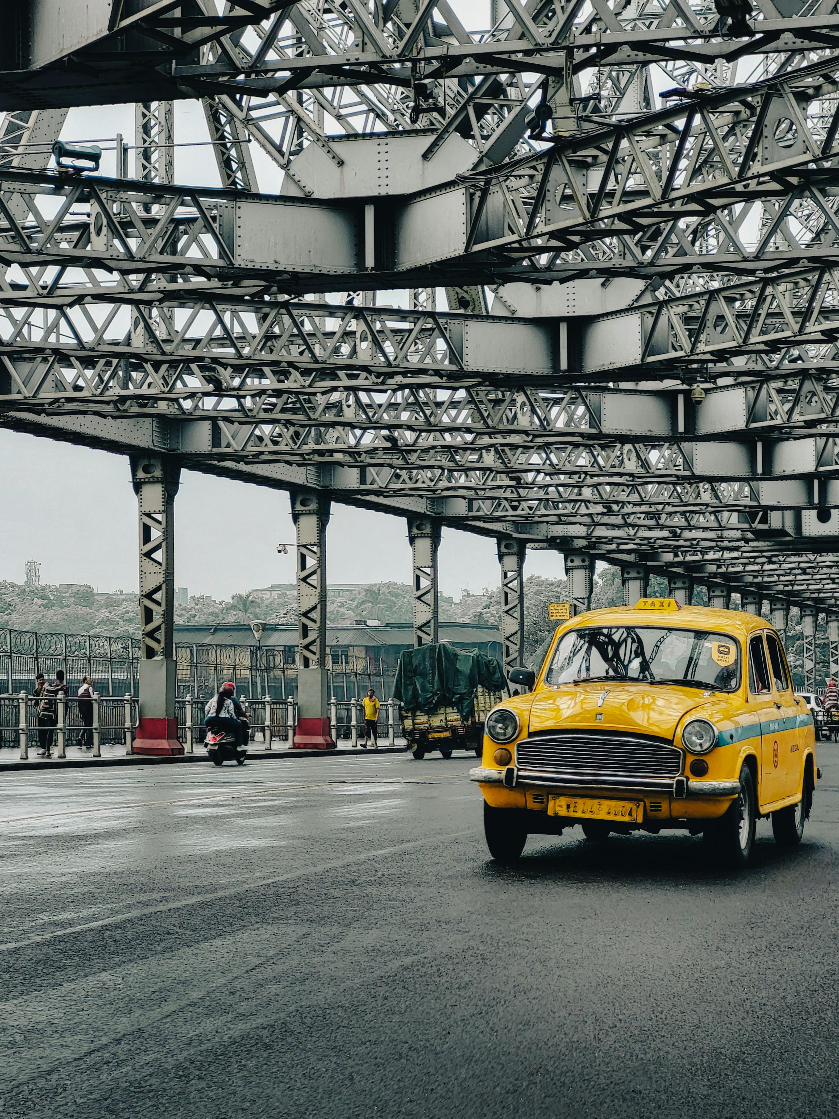 2776x3701 Yellow Hindustan Ambassador Taxi Running on Street · Free