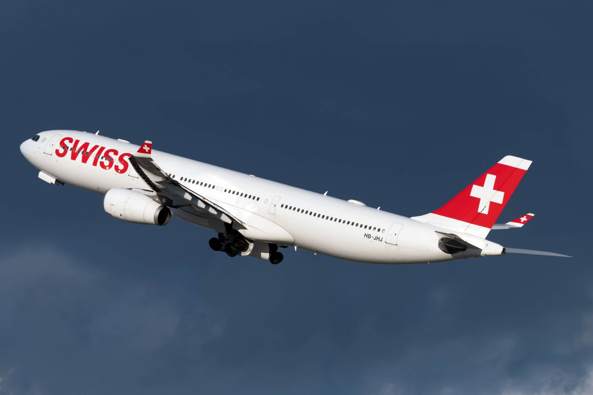 1920x1280 Download Swiss Airlines Plane Under The Dark Blue Sky Wallpaper