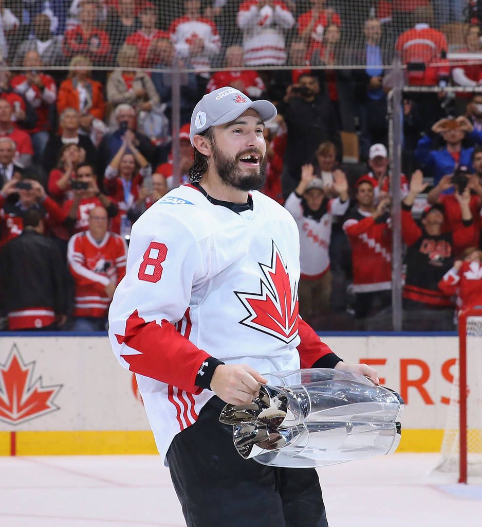 938x1024 Download Drew Doughty Joyfully Holding The World Cup Of Hockey Trophy, Showcasing His Characteristic Missing Tooth Grin Wallpaper