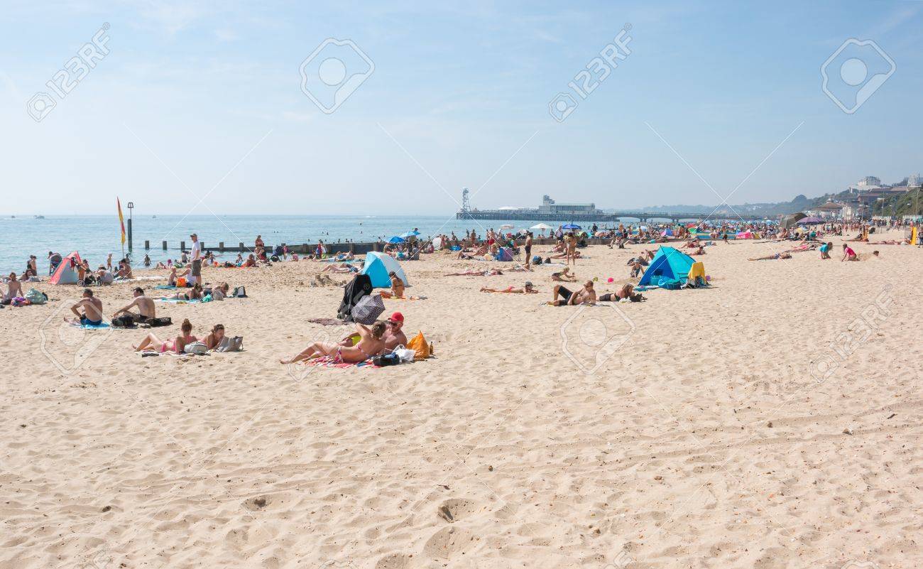 1300x801 Bournemouth, UK 2017:Busy Beach In A Hot Summer Day With Pier Amusements In The Background , Picture and Royalty Free Image. Image 85228559
