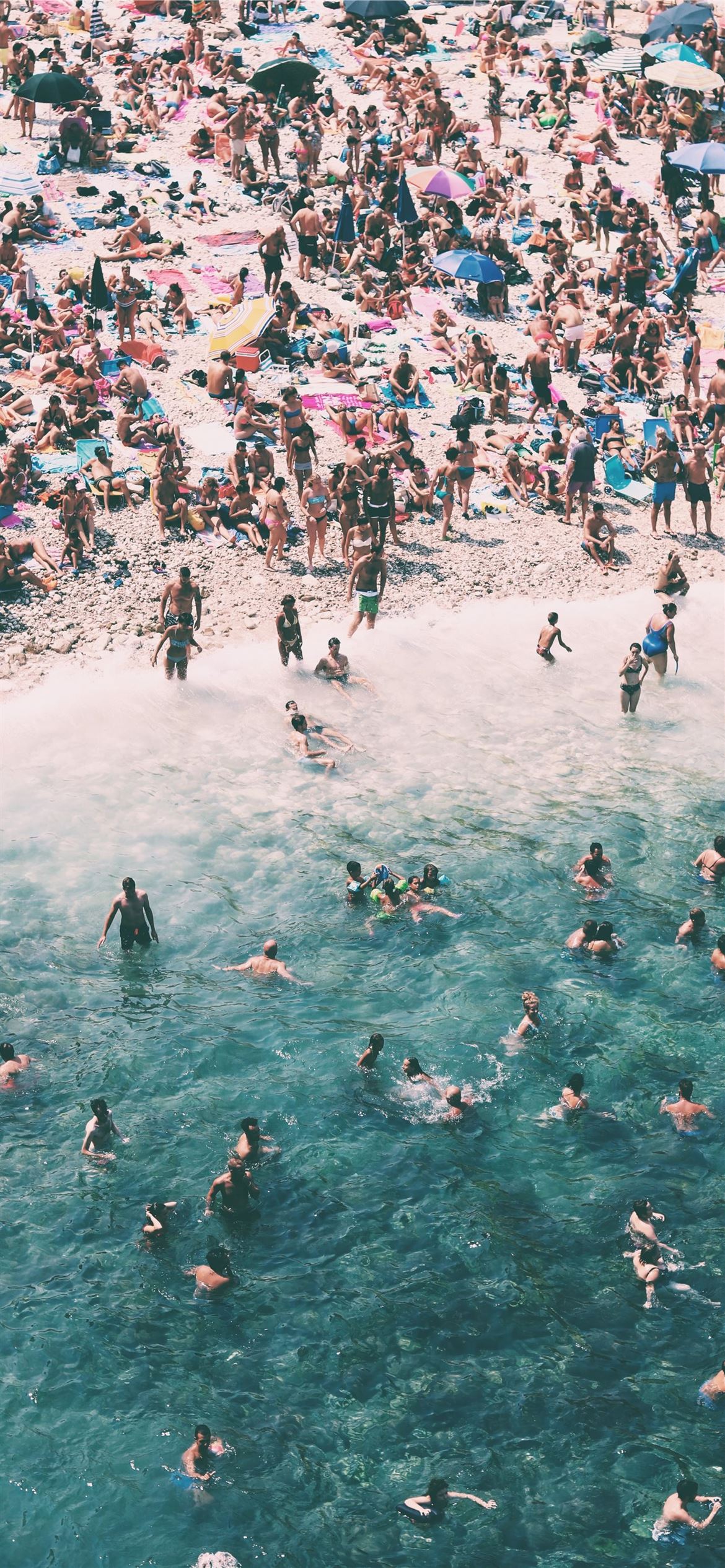 1170x2532 crowded people gathered on beach iPhone 12 Wallpaper Free Download