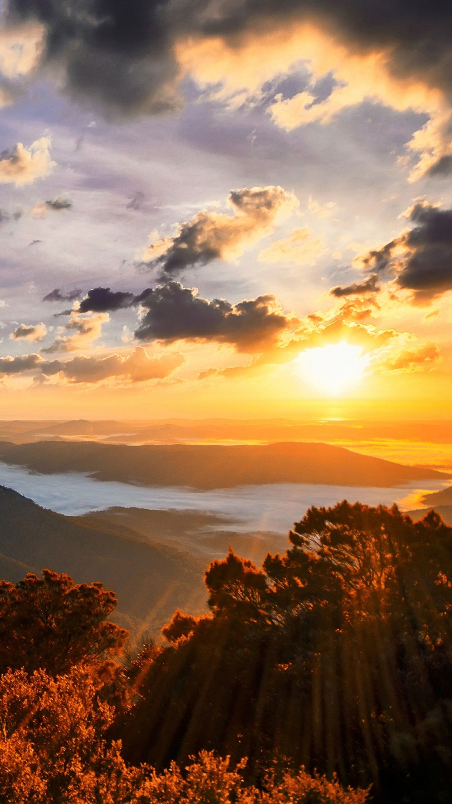 1440x2560 Bright Sunlight Shining Through Hole Of Clouds To Dark Scene Of Mountains 4K HD Nature Wallpaper
