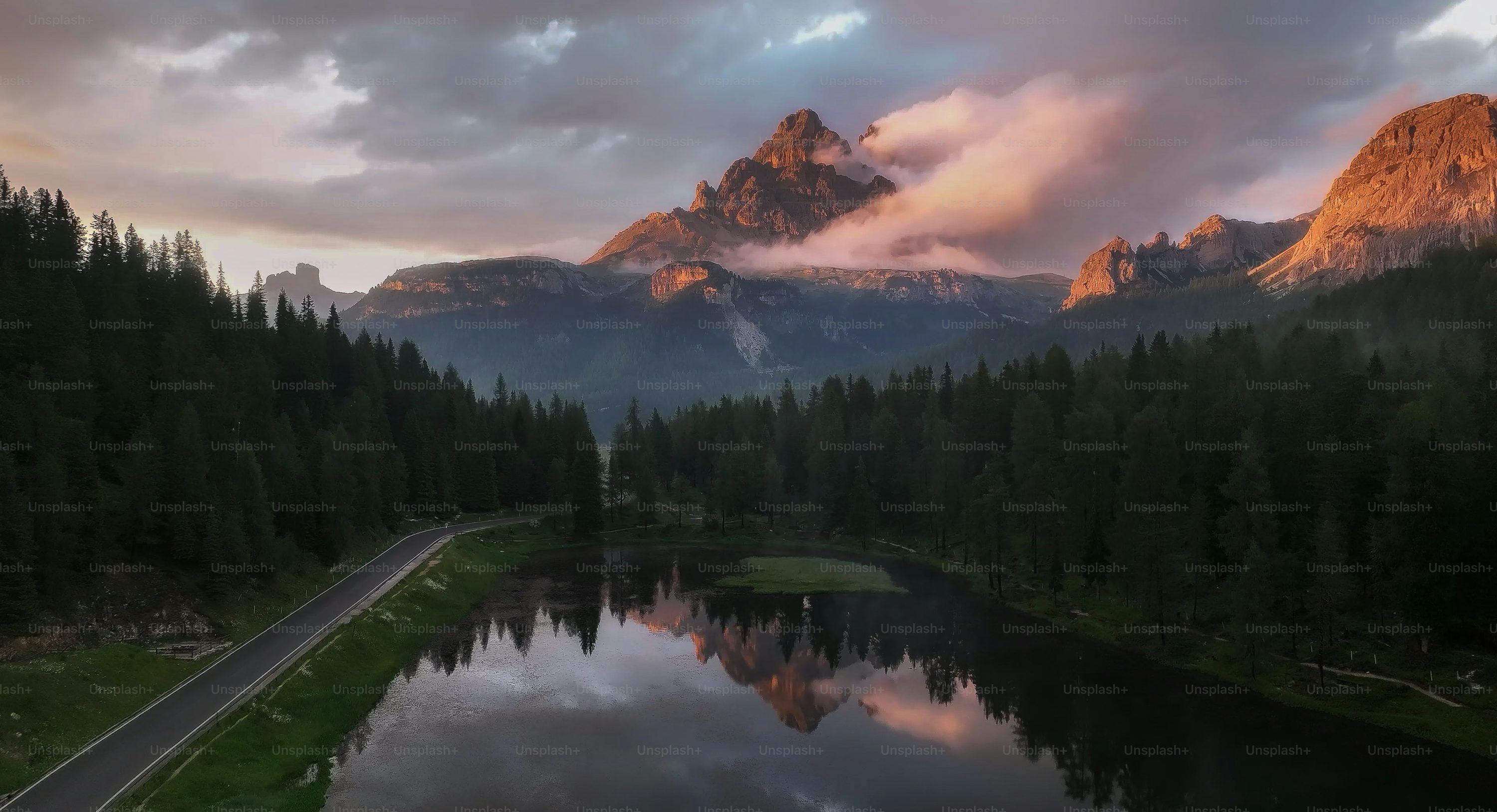 3000x1628 A scenic view of a mountain range with a lake in the foreground photo