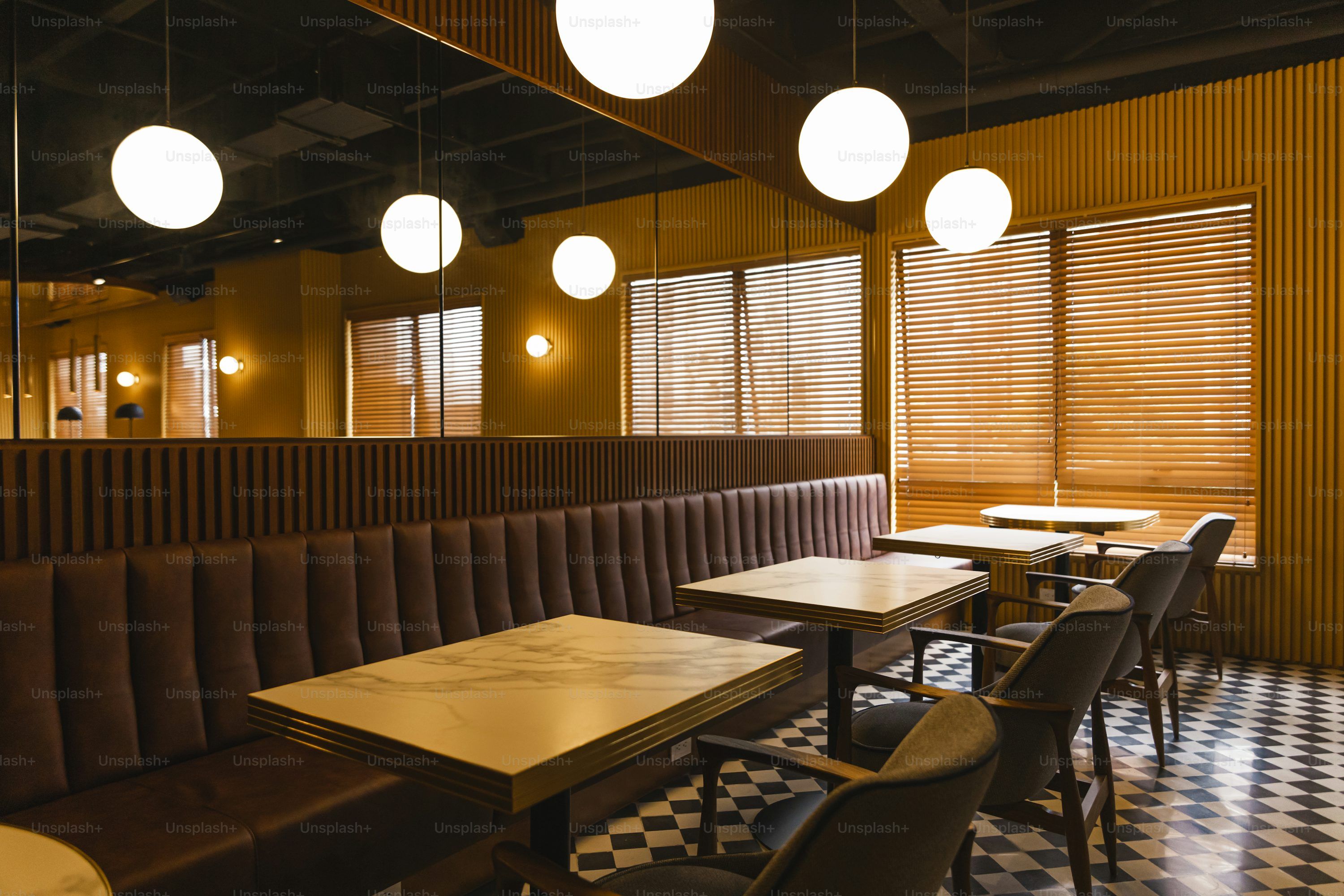 3000x2000 A coffee shop interior with tables and a wall mural. photo