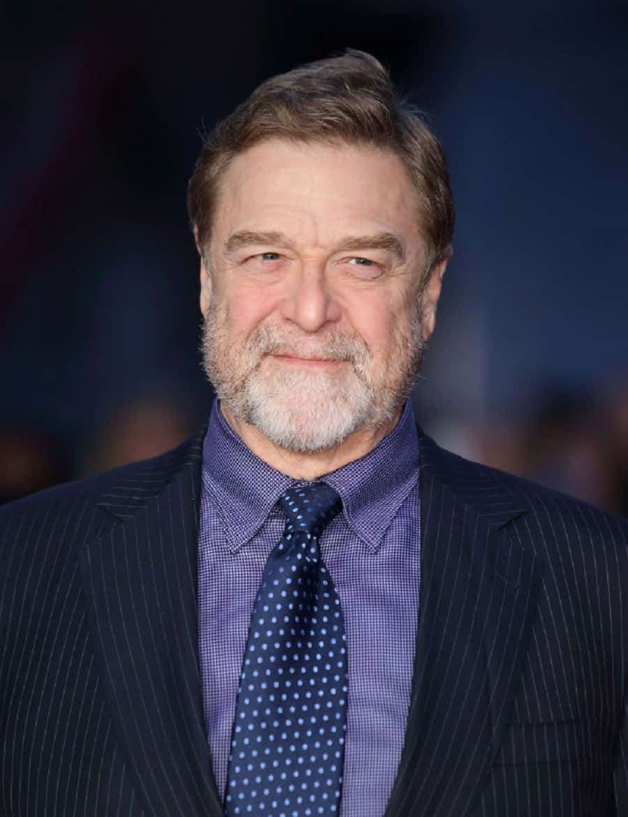 900x1170 Download John Goodman Smiling in a Suit Wallpaper