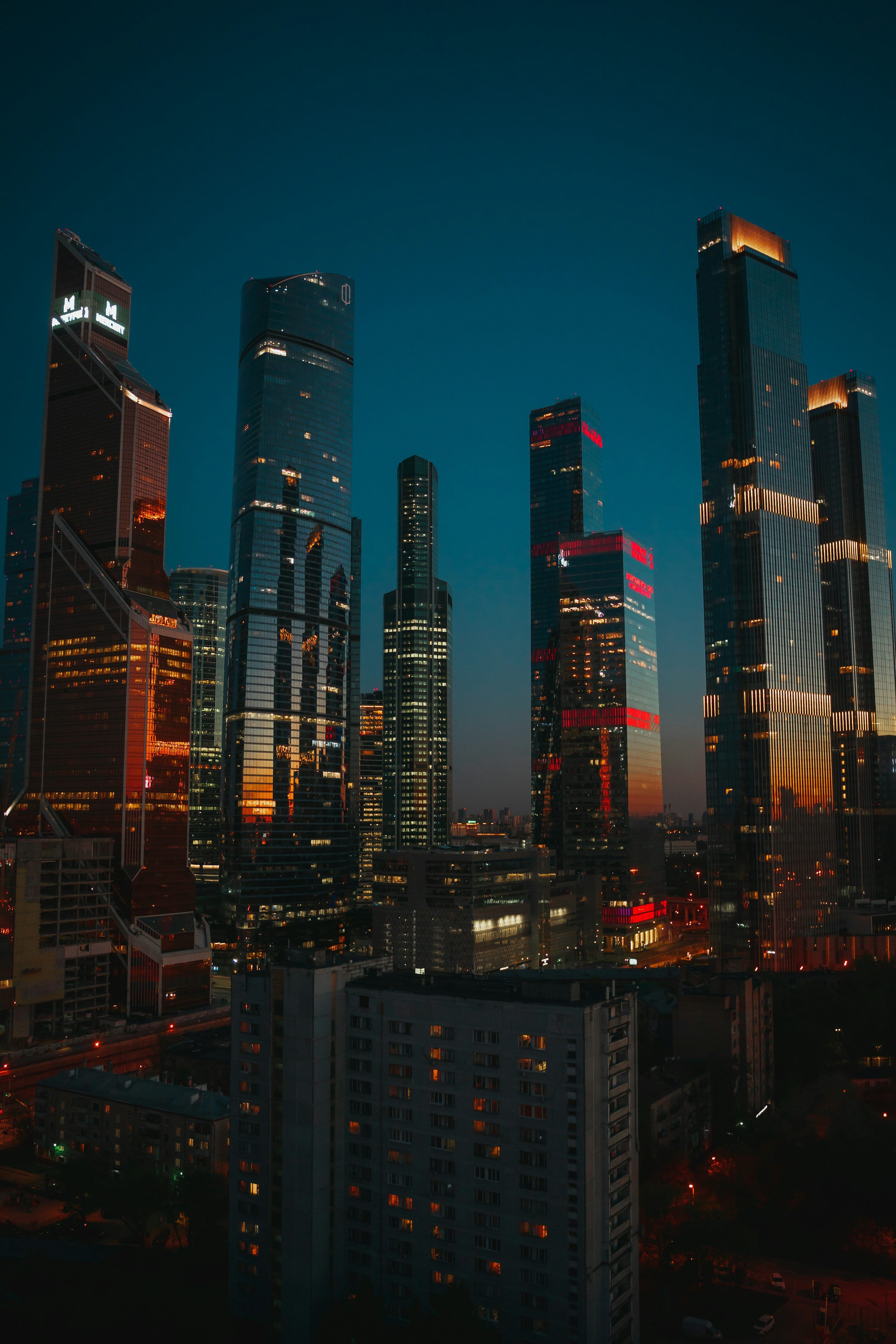 3000x4500 A view of a city at night from the top of a building photo