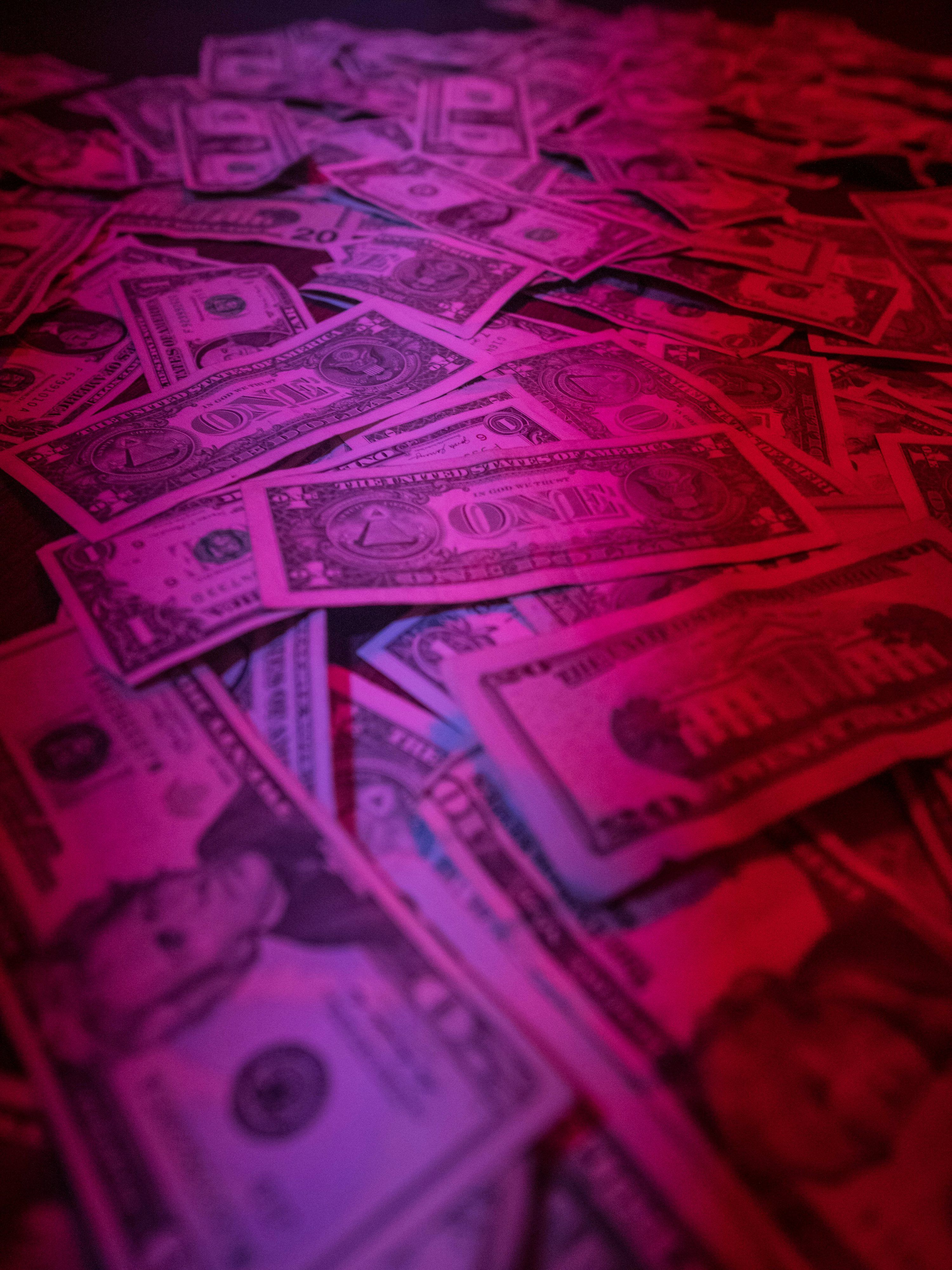 3000x4000 A pile of money sitting on top of a table photo