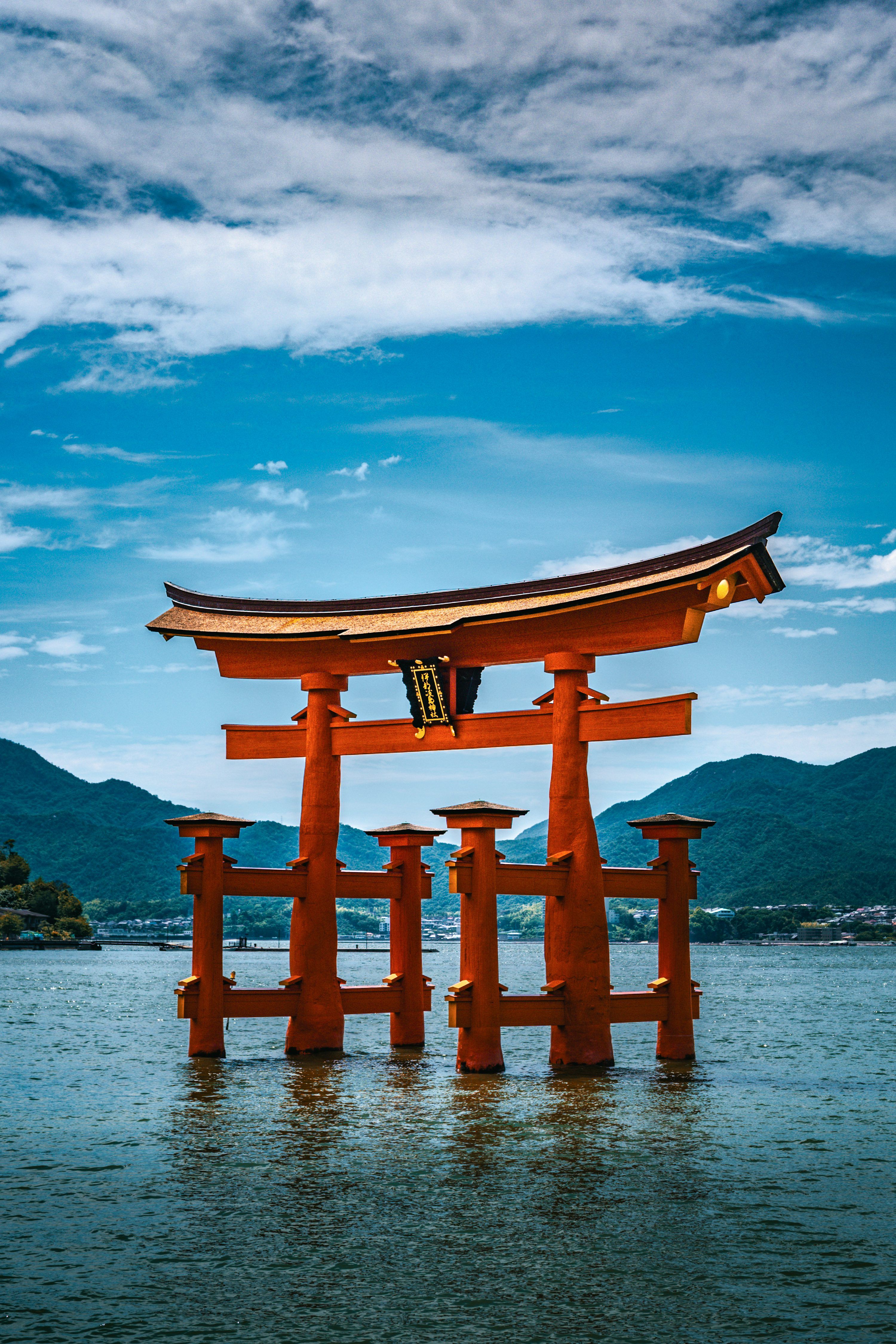 3000x4500 A famous japanese torii gate stands in the water. photo