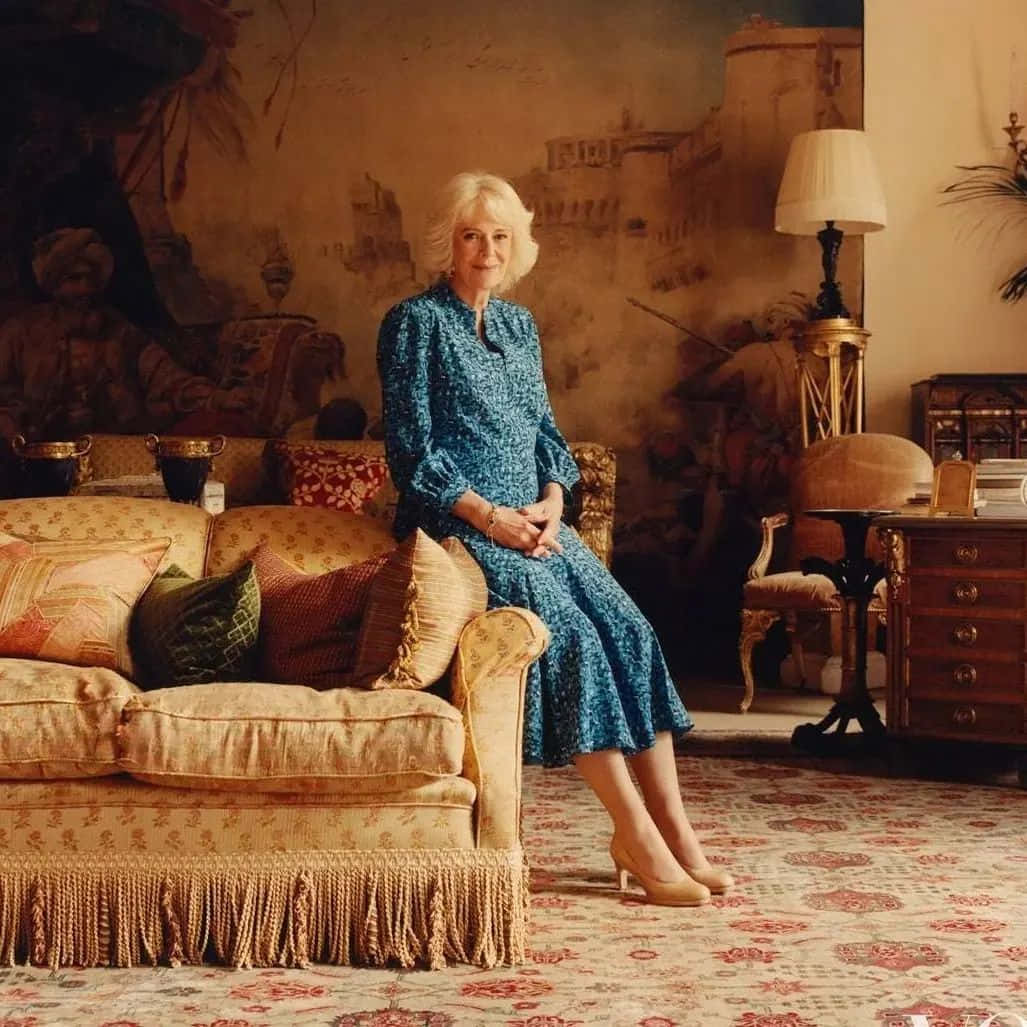 1027x1027 Download Queen Camilla Sitting On Sofa Wallpaper