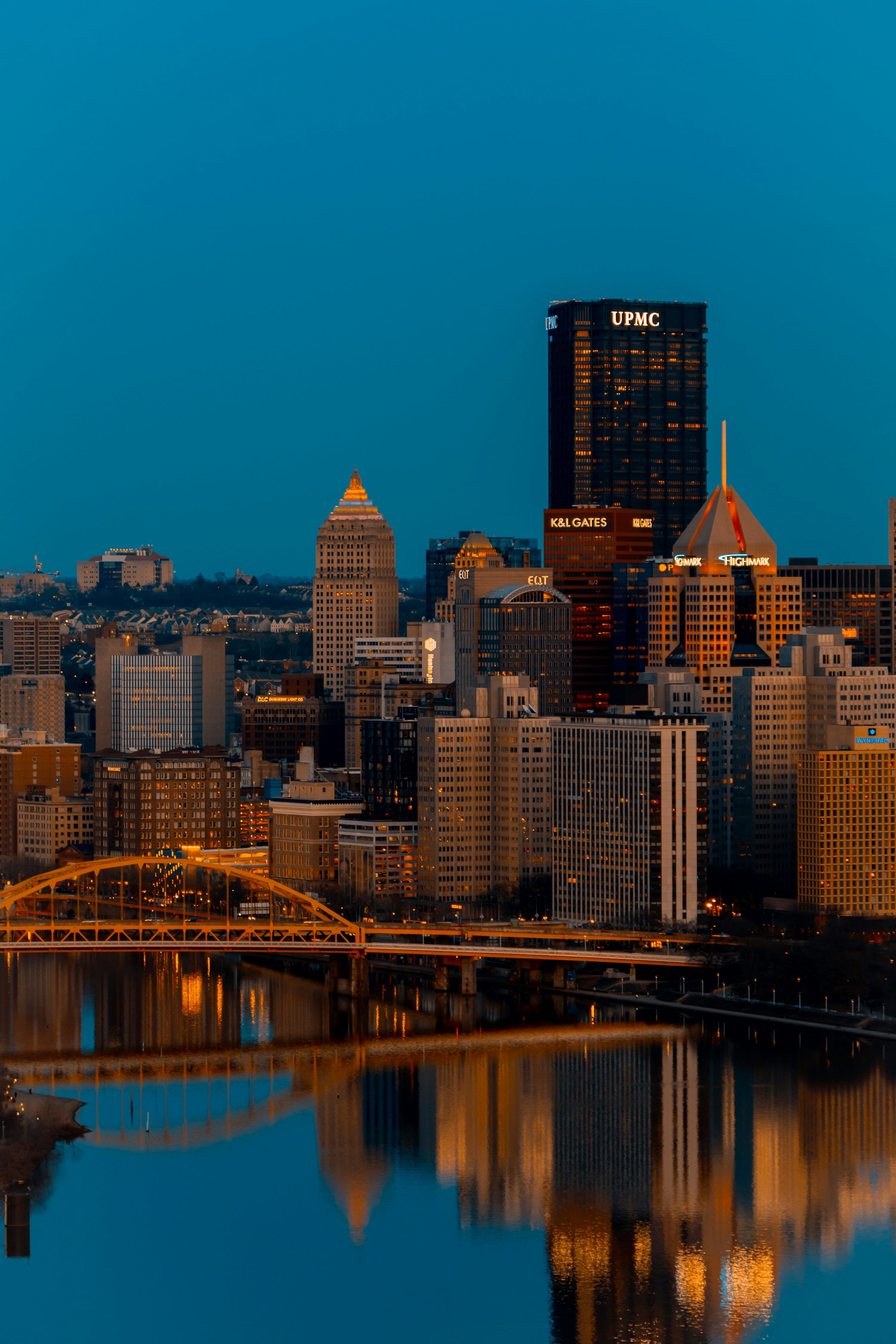 3000x4500 A city skyline with a bridge over a river photo