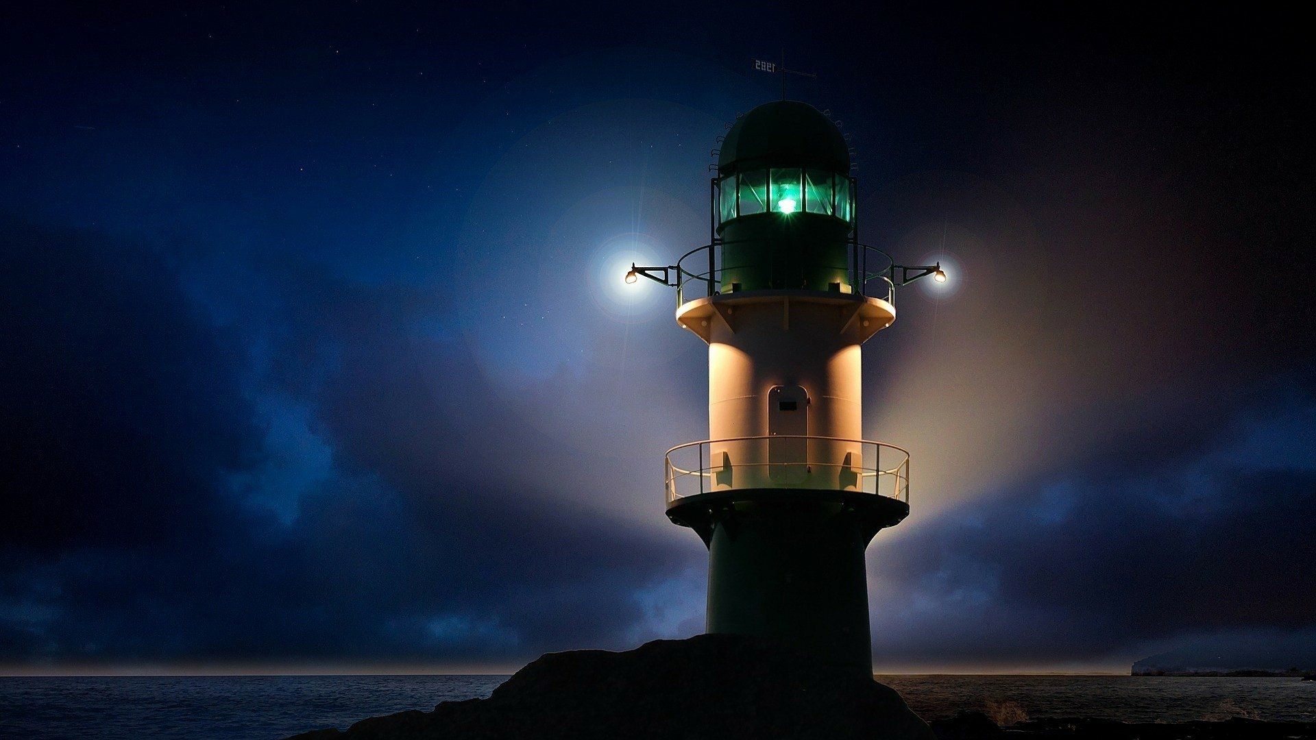 1920x1080 Guiding Light: Nighttime Ocean Lighthouse HD Wallpaperx1080