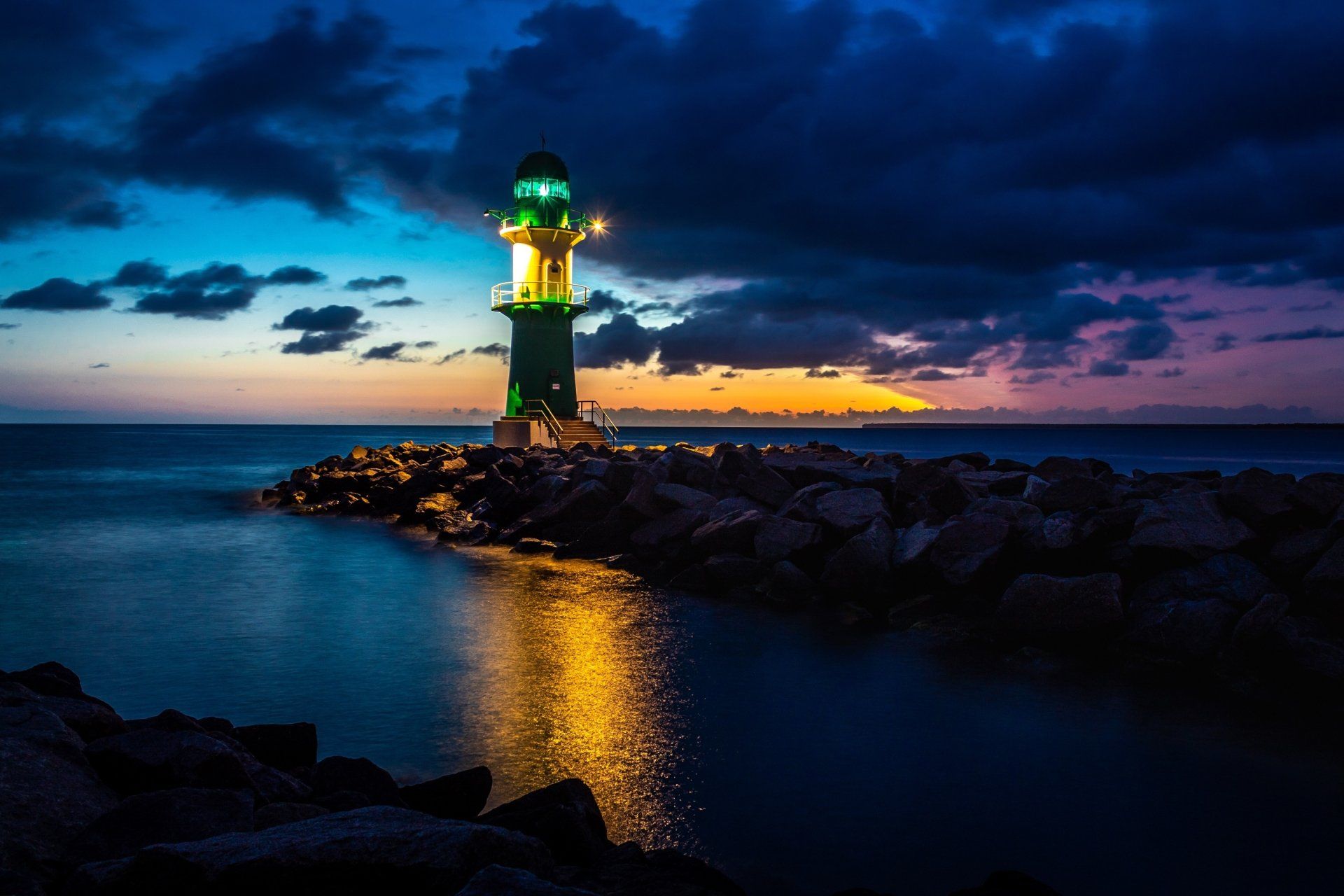 1920x1280 Guiding Light: Nighttime Lighthouse Over Ocean Under Clouded Sky HD Wallpaperx2000