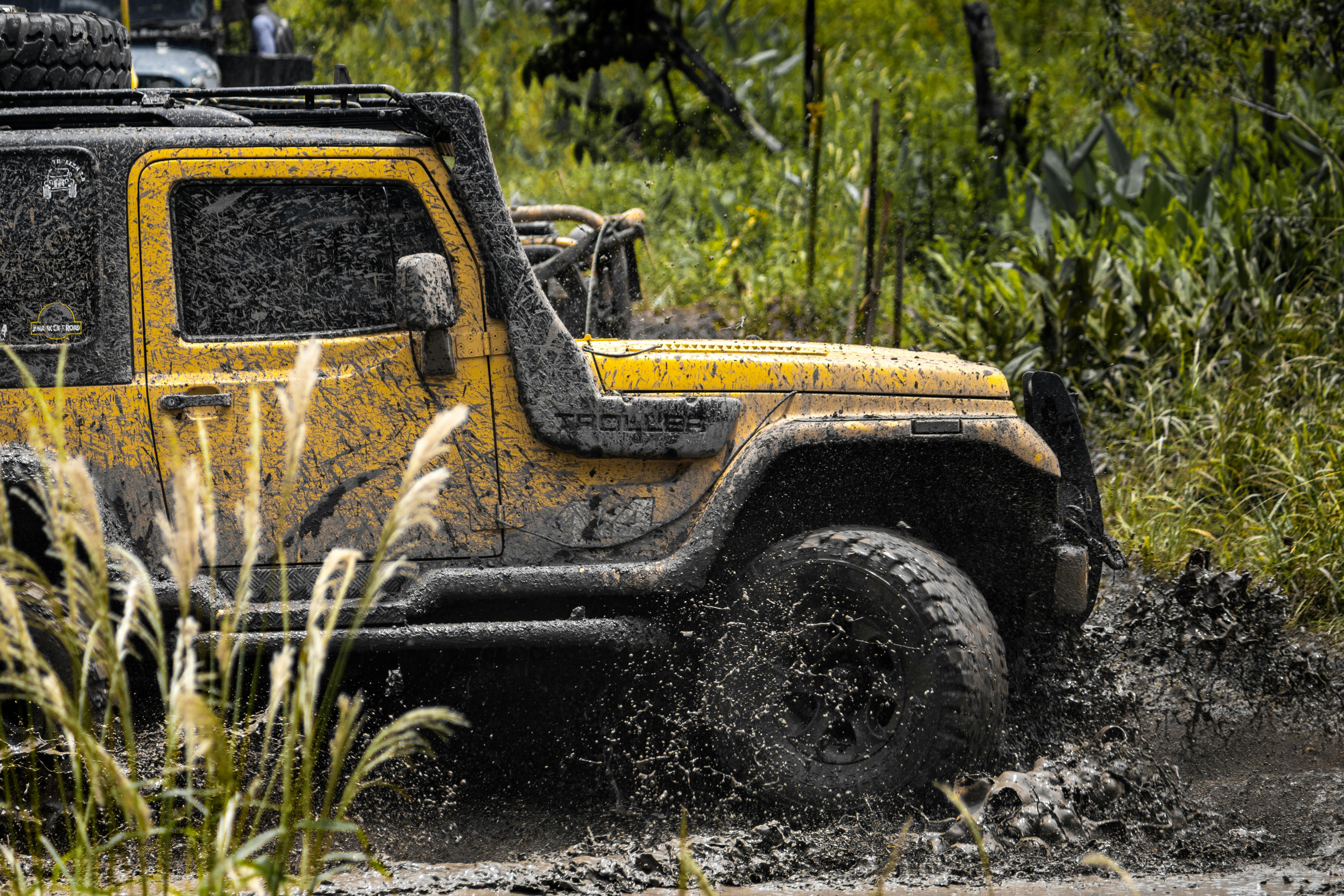 5018x3345 Yellow Jeep on Muddy Terrain · Free