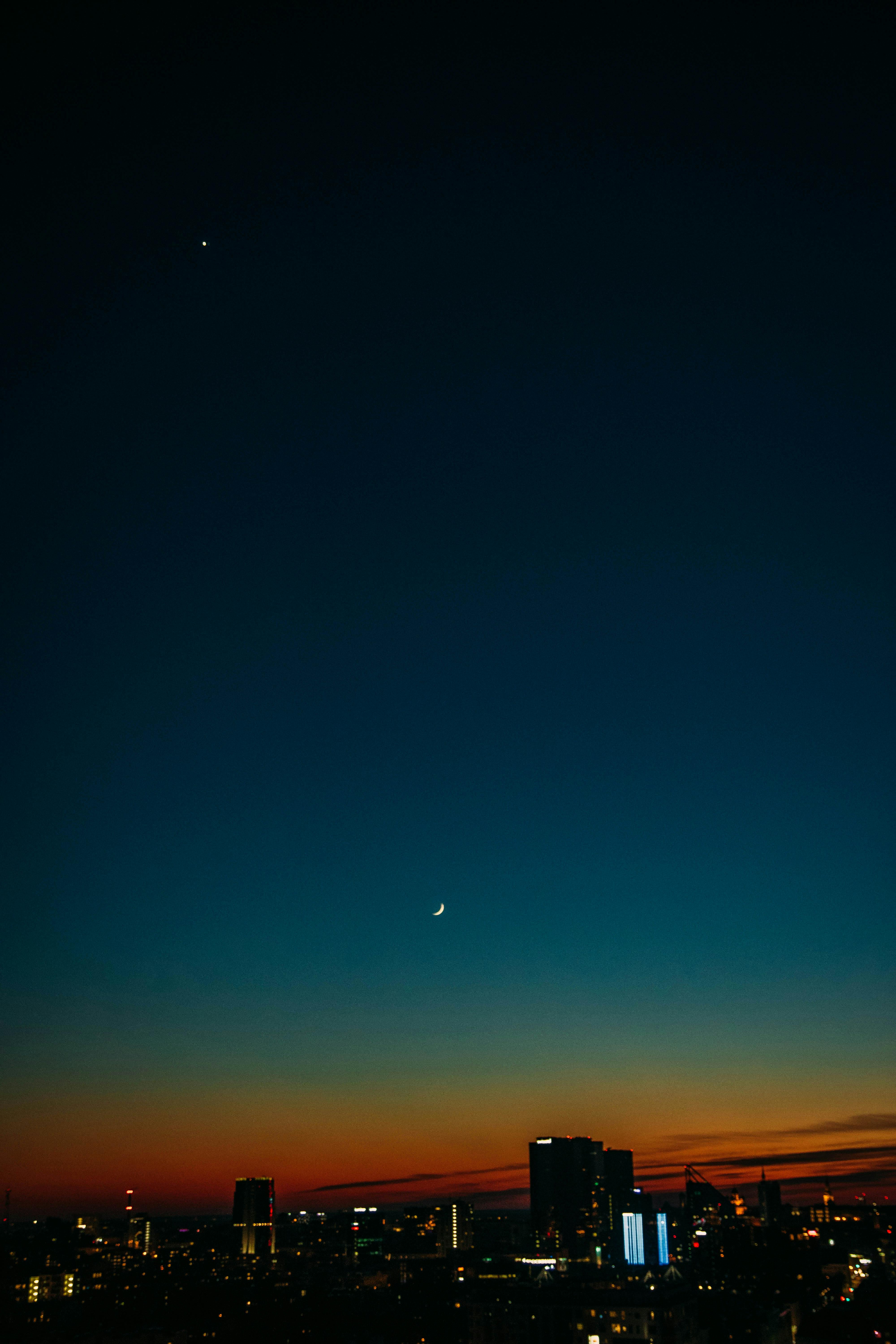 4000x6000 Colorful night sky with moon above city buildings at sunset · Free