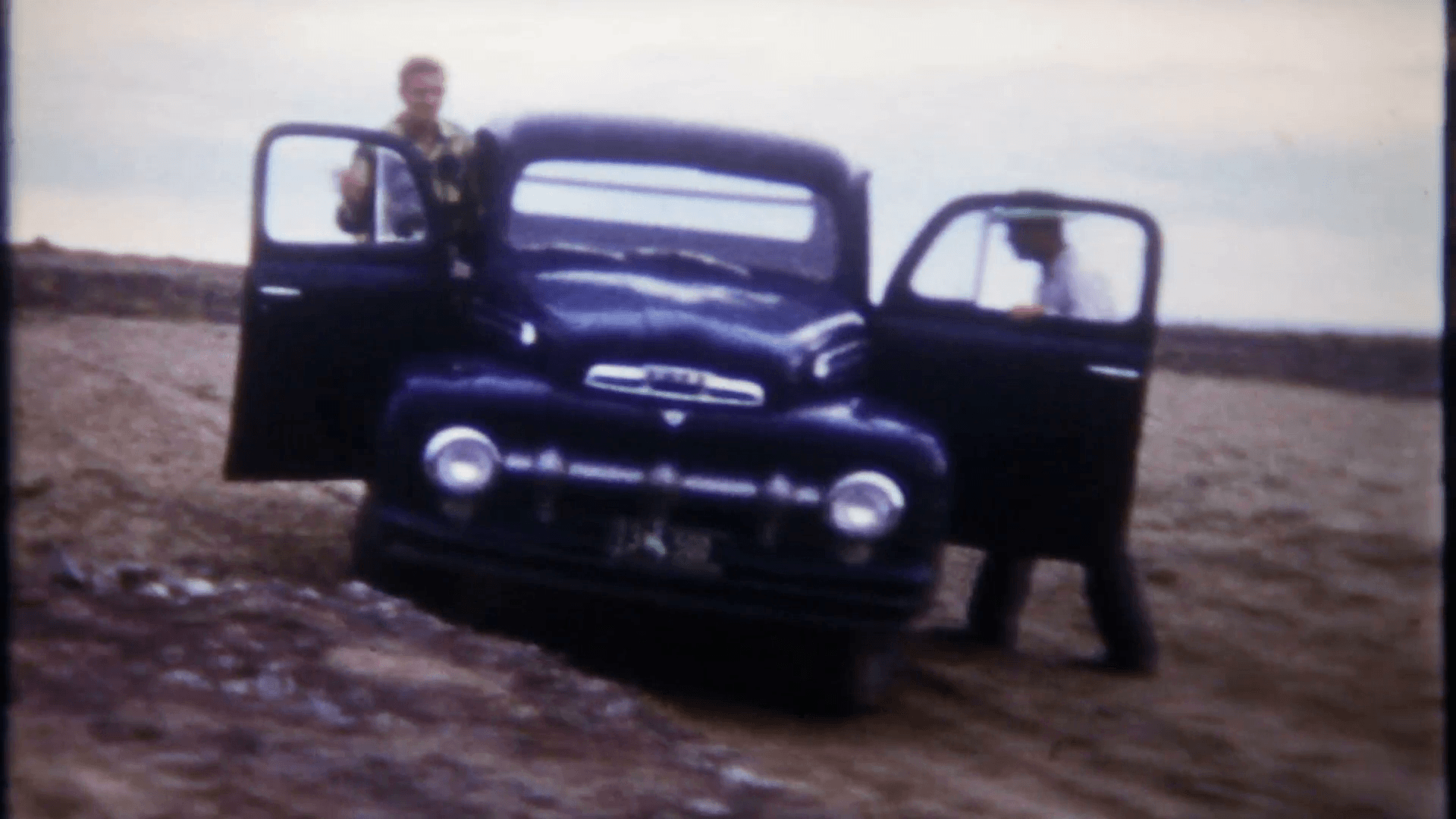 1920x1080 men drive a vintage 1950's pickup truck on a rough desert