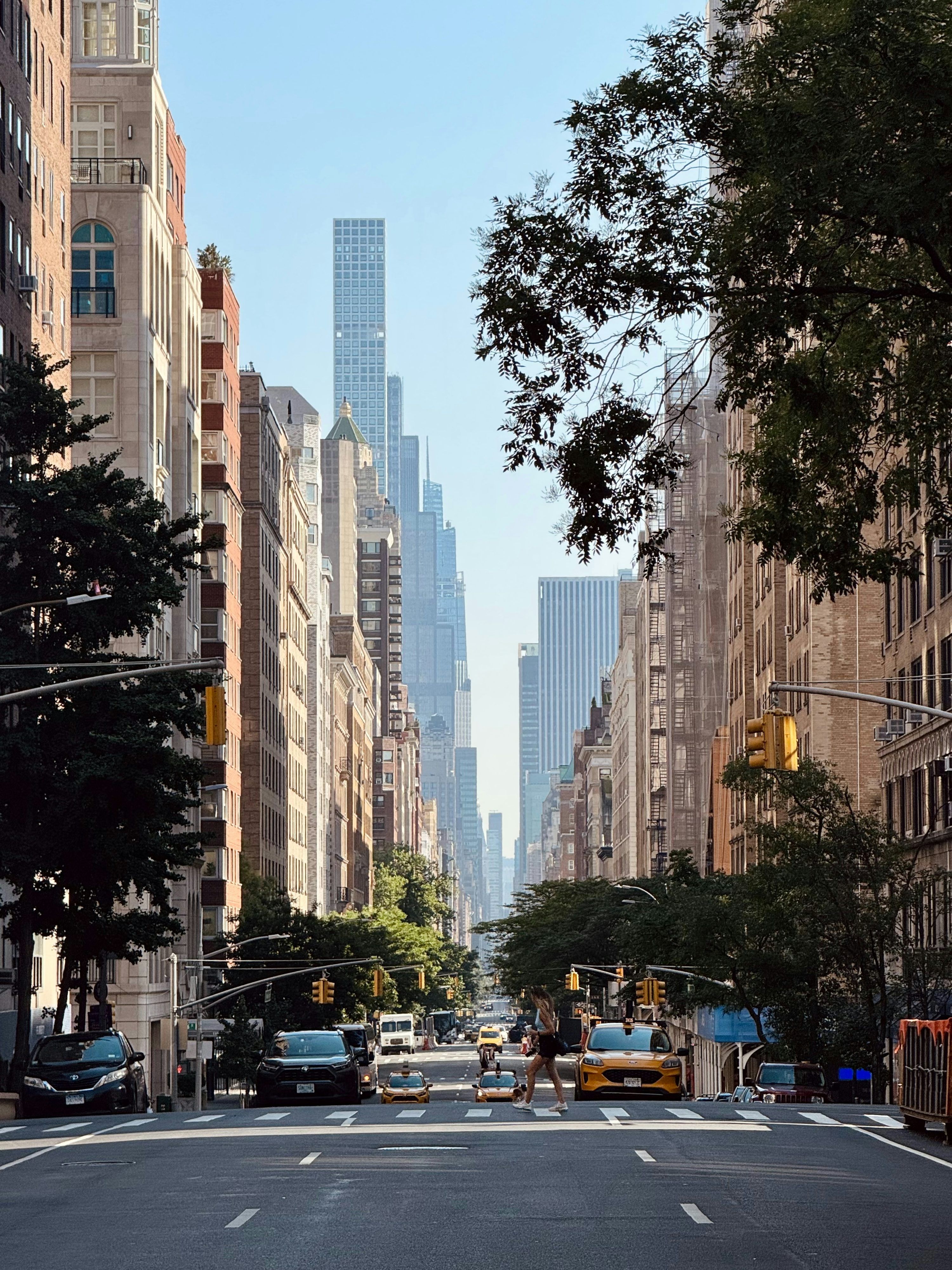 3000x4000 Skyscrapers dominate a sunny new york city street. photo