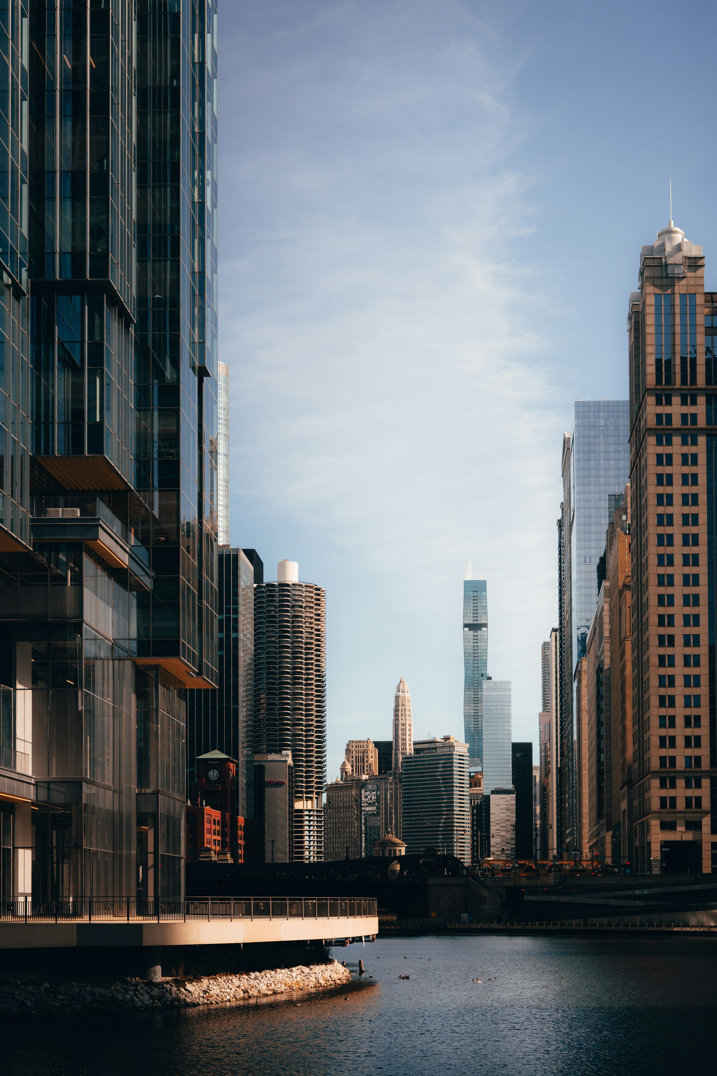 3000x4500 Skyscrapers line a river on a sunny day. photo