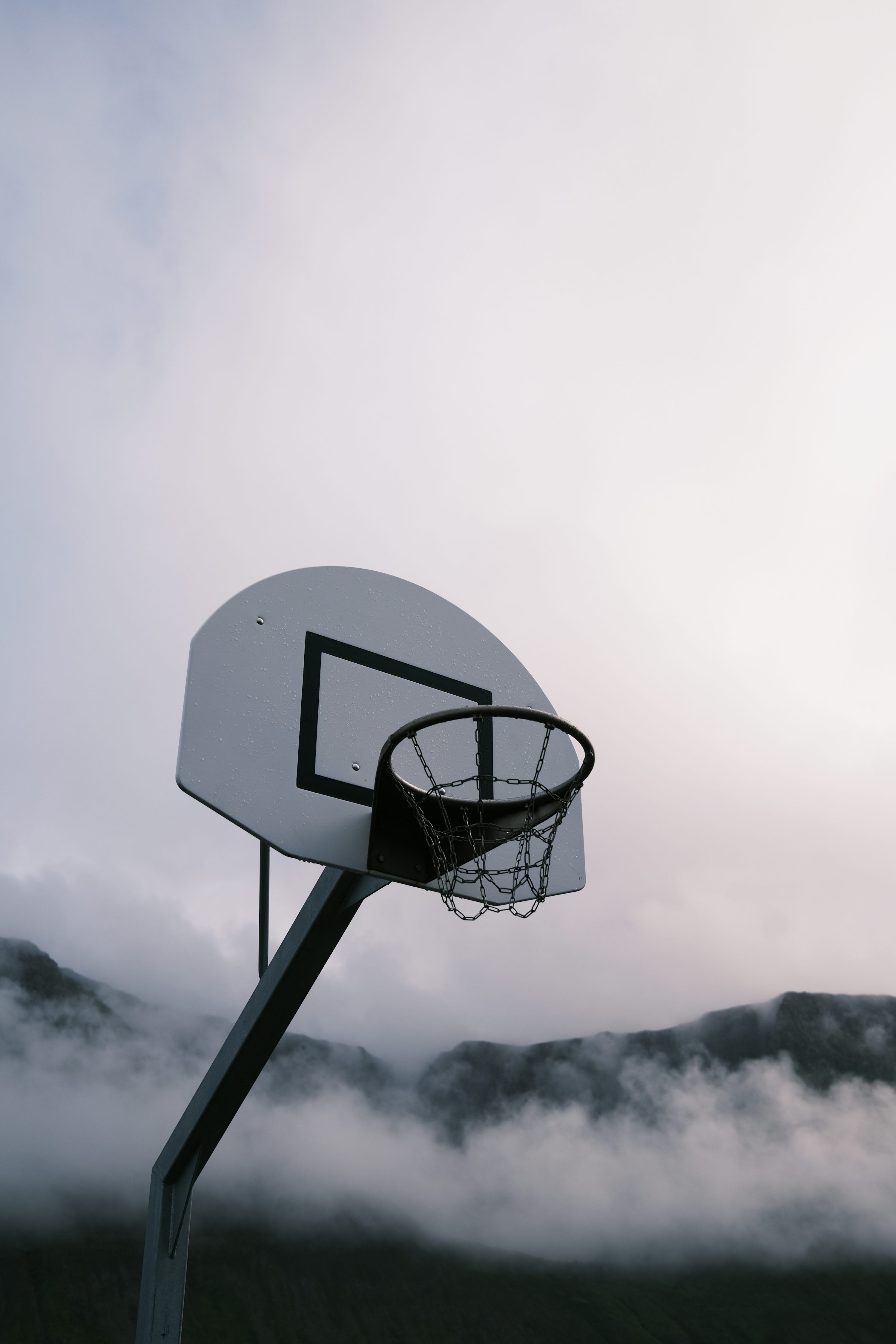 3000x4500 A basketball hoop in the middle of a foggy field photo