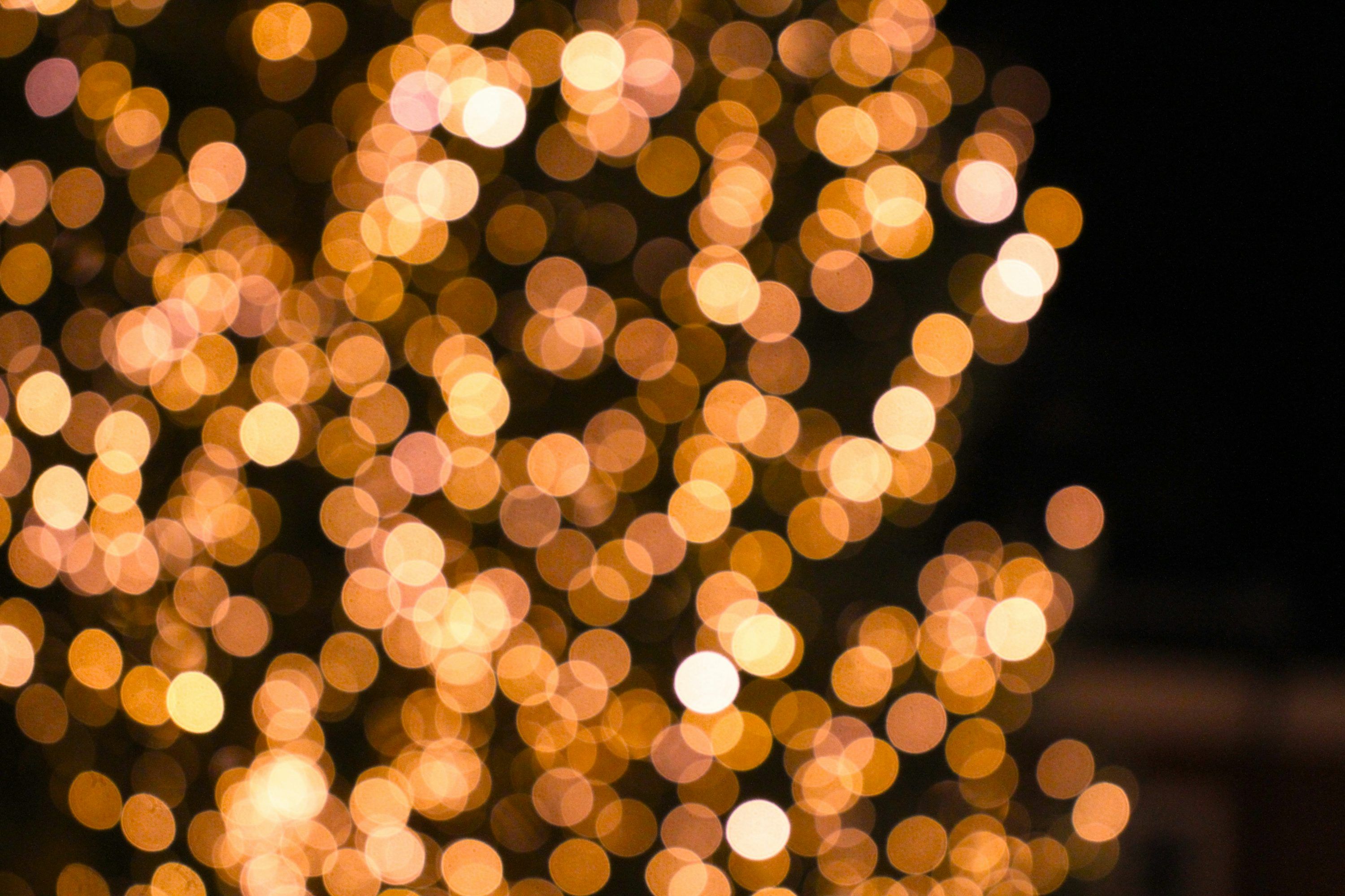 3000x2000 Golden bokeh lights against a dark background photo