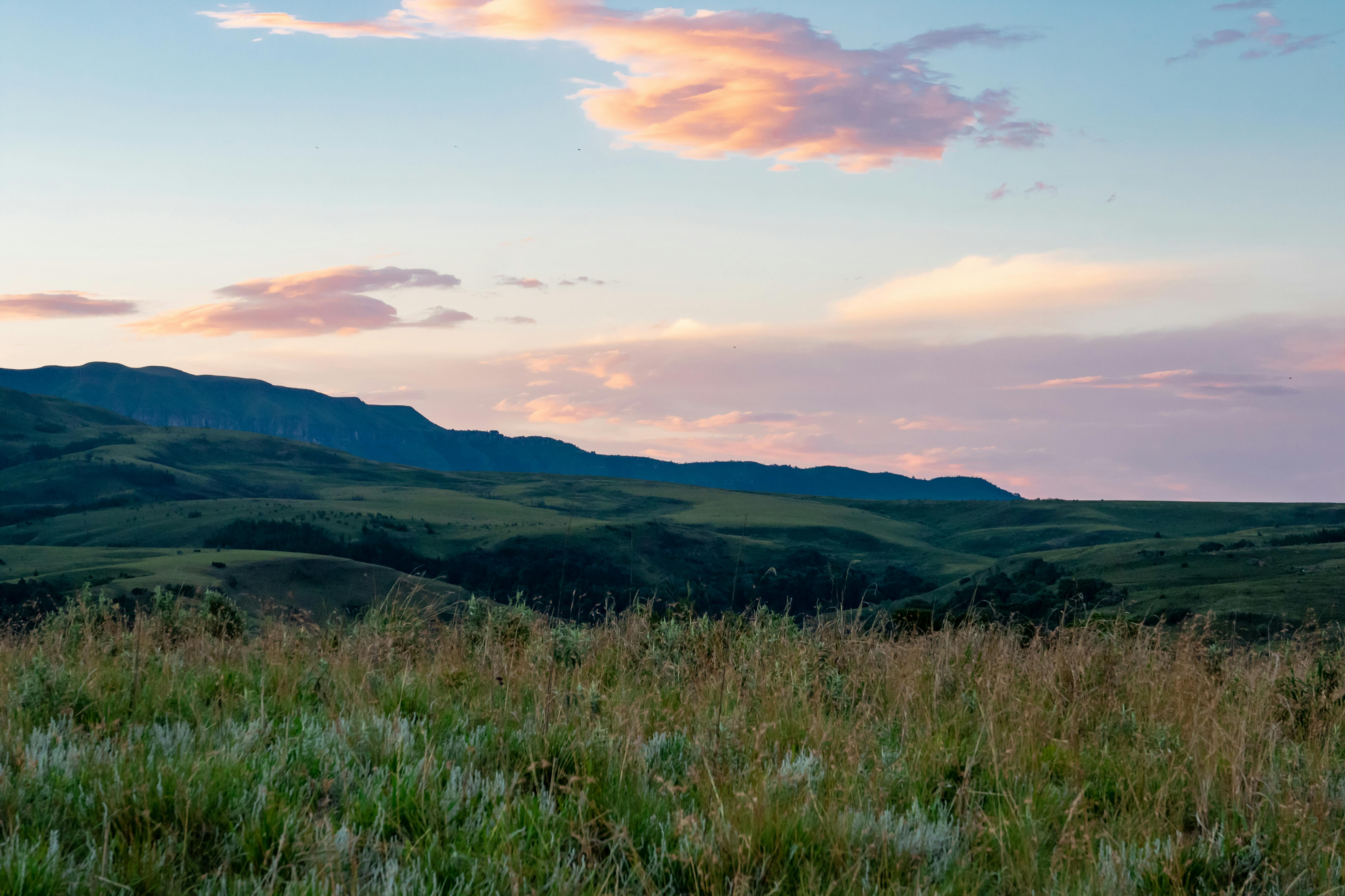 5472x3648 Grass Field Near Hill Under Cloudy Sky · Free