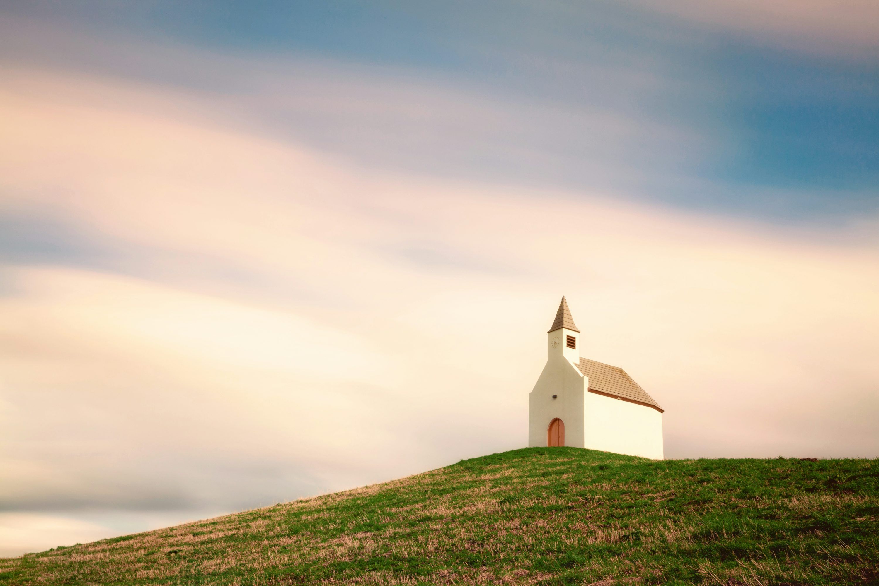 3000x2002 A small church on a hill with a sky background photo