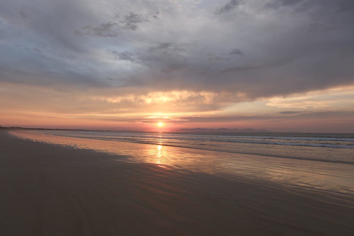 1125x750 Serene Beach Sunset Reflected on Sand at Twilight · Free