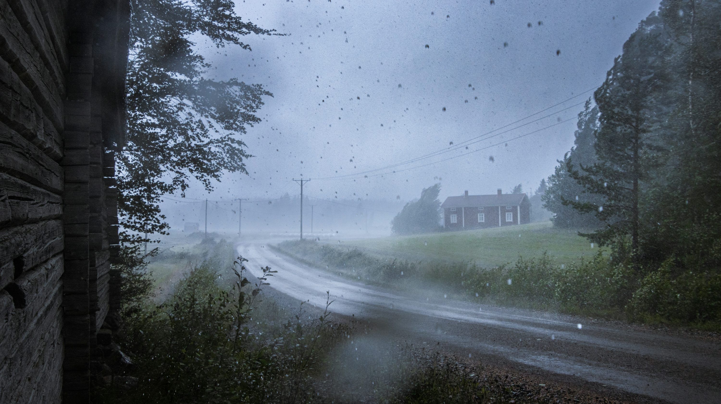 3000x1683 A house in the middle of a road on a rainy day photo