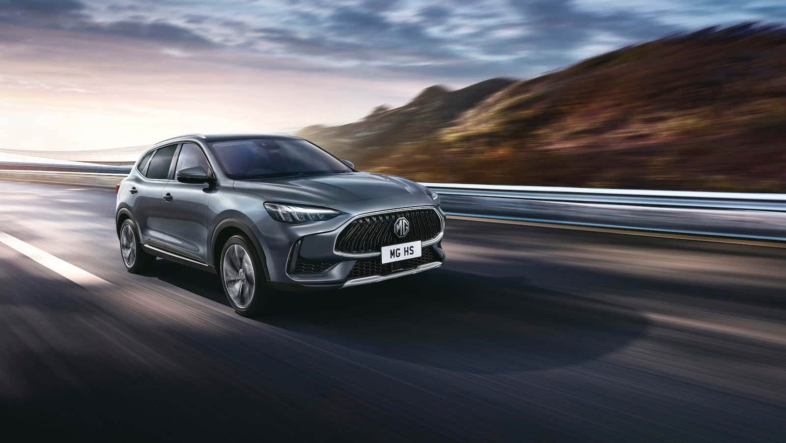 1600x902 Download Premium MG Motors Car against a Scenic Backdrop Wallpaper