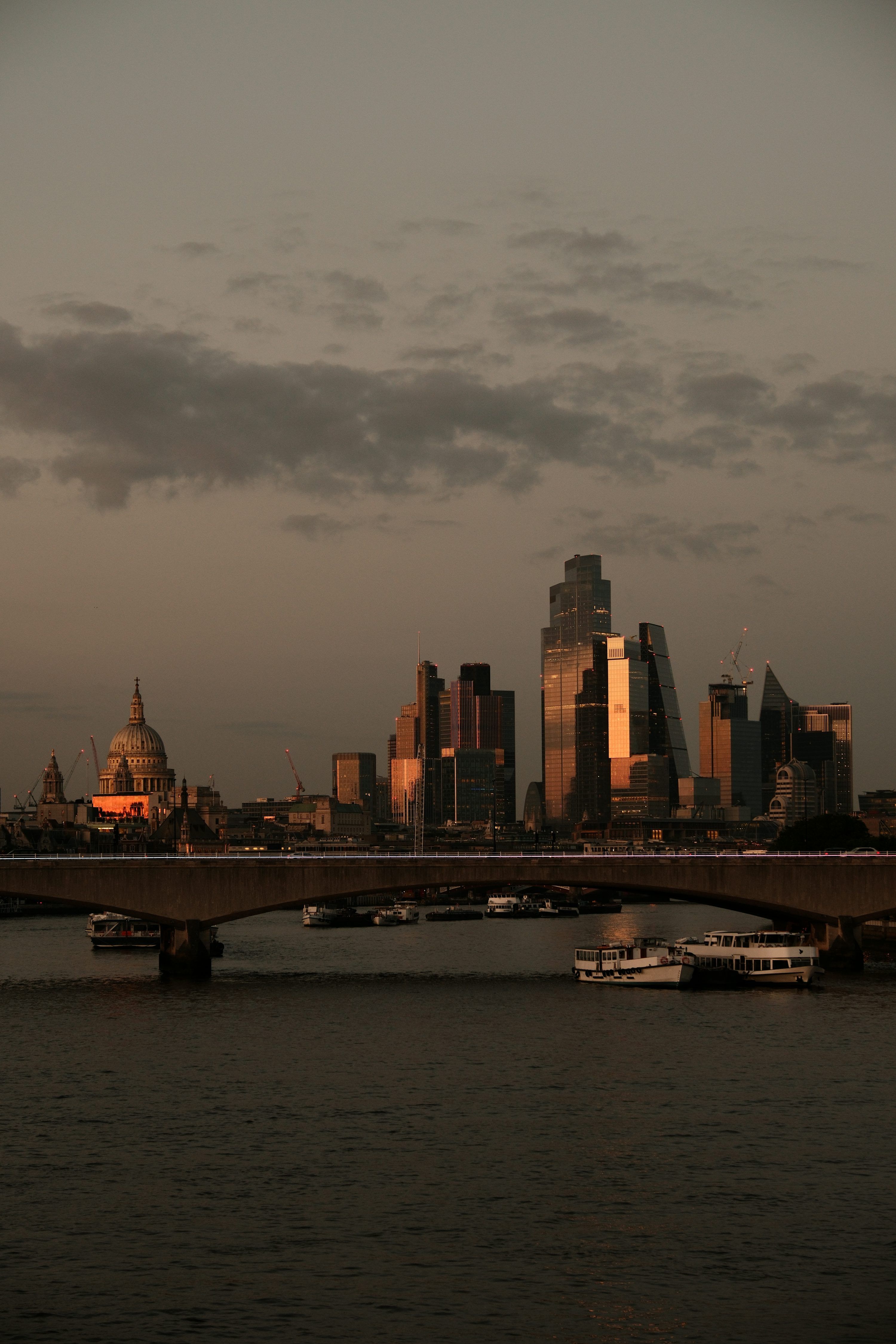 3000x4500 A bridge over a river with a city in the background photo