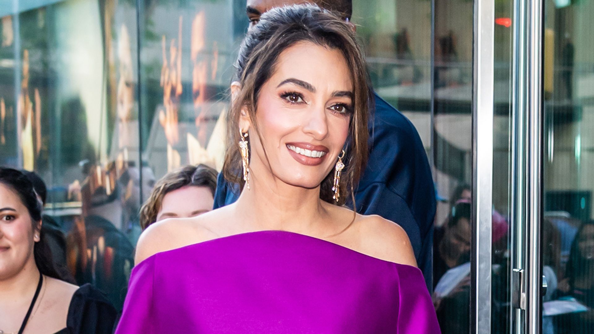 1920x1080 Amal Clooney puts a chic spin on the mini dress, showing off her legs in a bold purple look and gold pumps