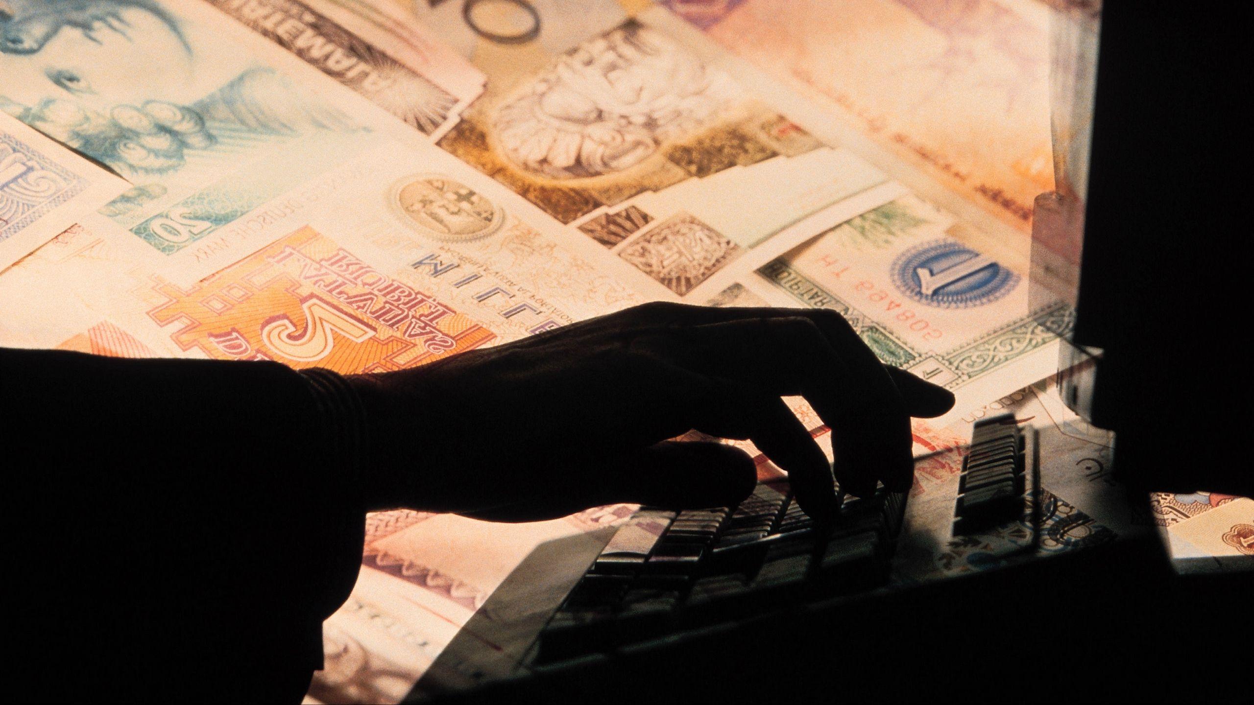 2560x1440 Download wallpaper 2560x1440 money, gold, hand, computer, business