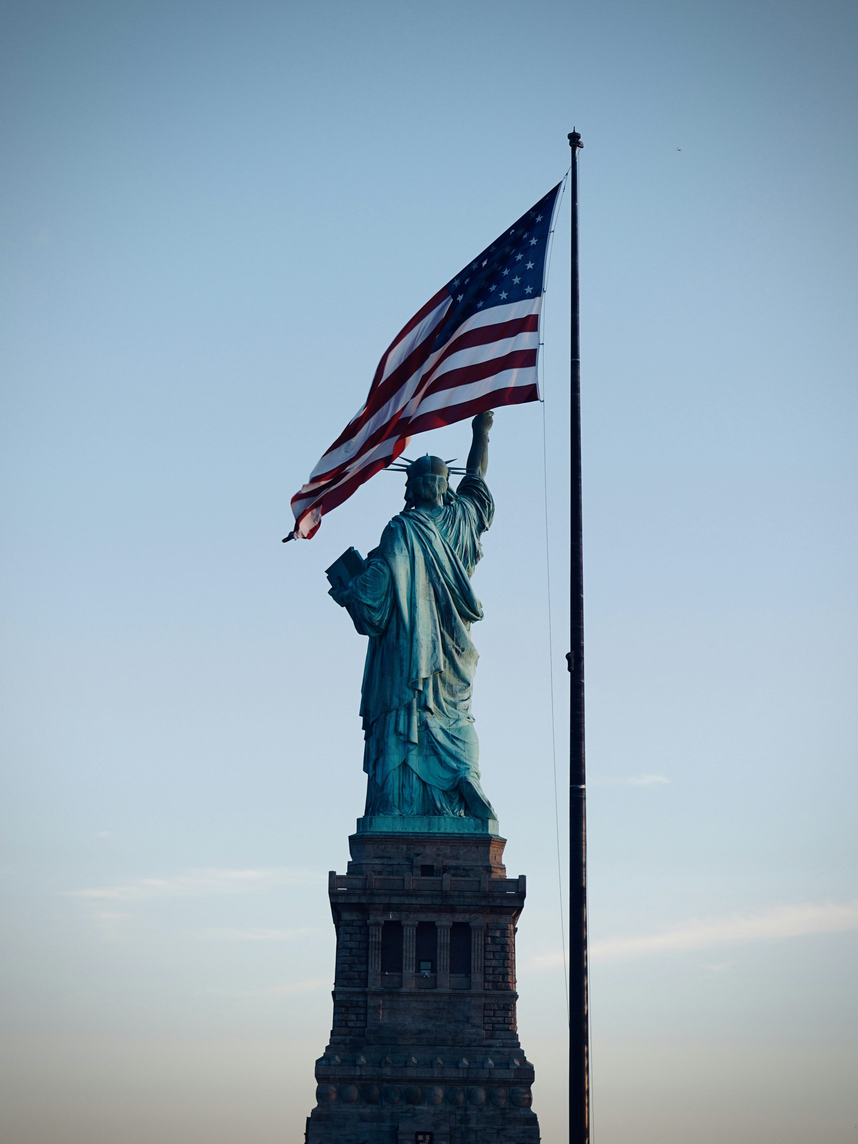 3000x4000 The statue of liberty is holding the american flag photo
