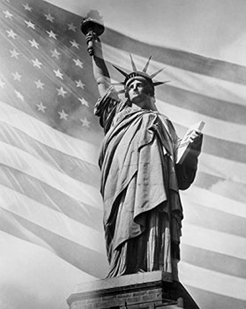 798x1000 Posterazzi Low angle view American flag in the background Statue of Liberty City New York USA Poster Print, (18 x 24): Posters & Prints