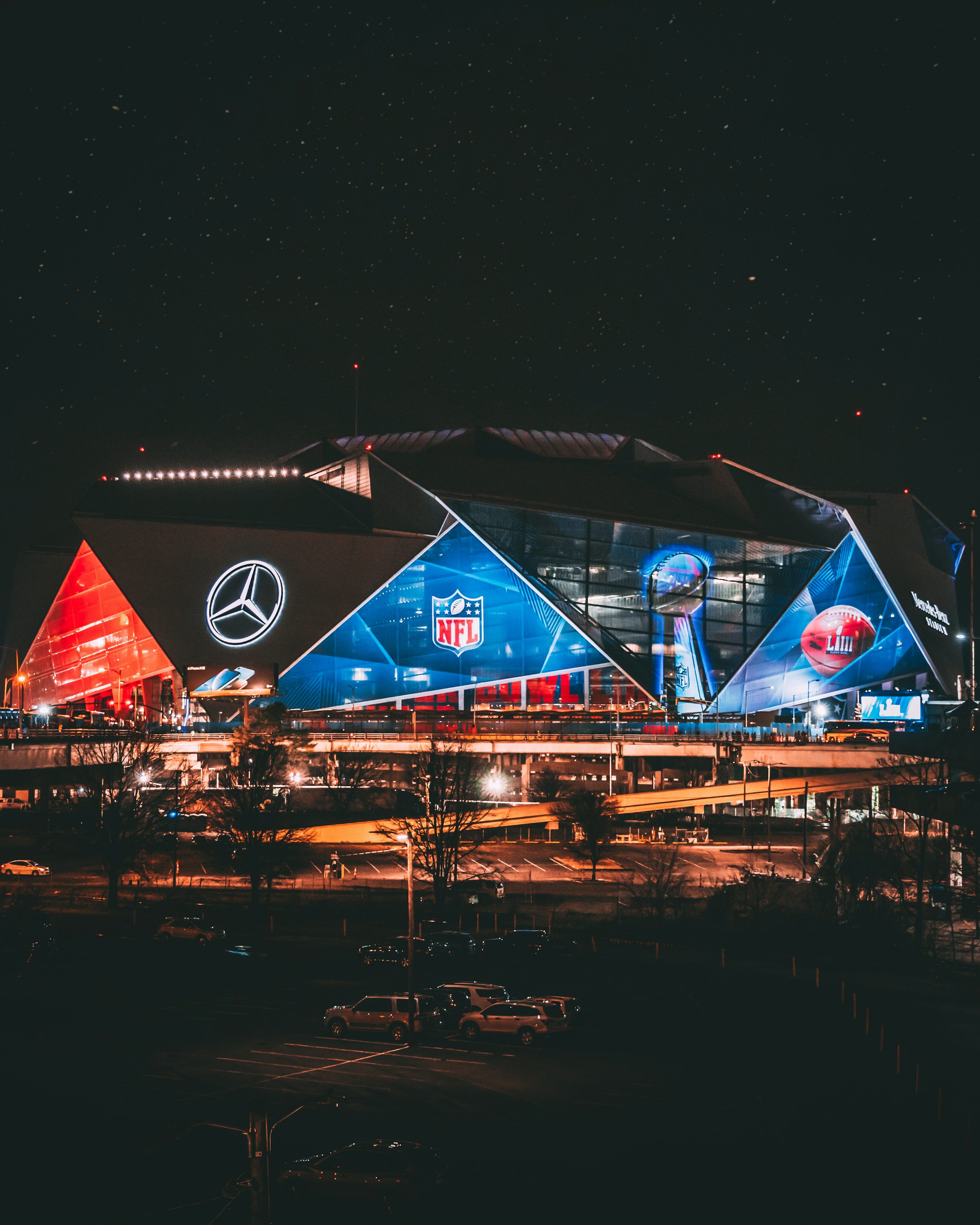 3000x3750 A stadium lit up at night with a lot of lights photo