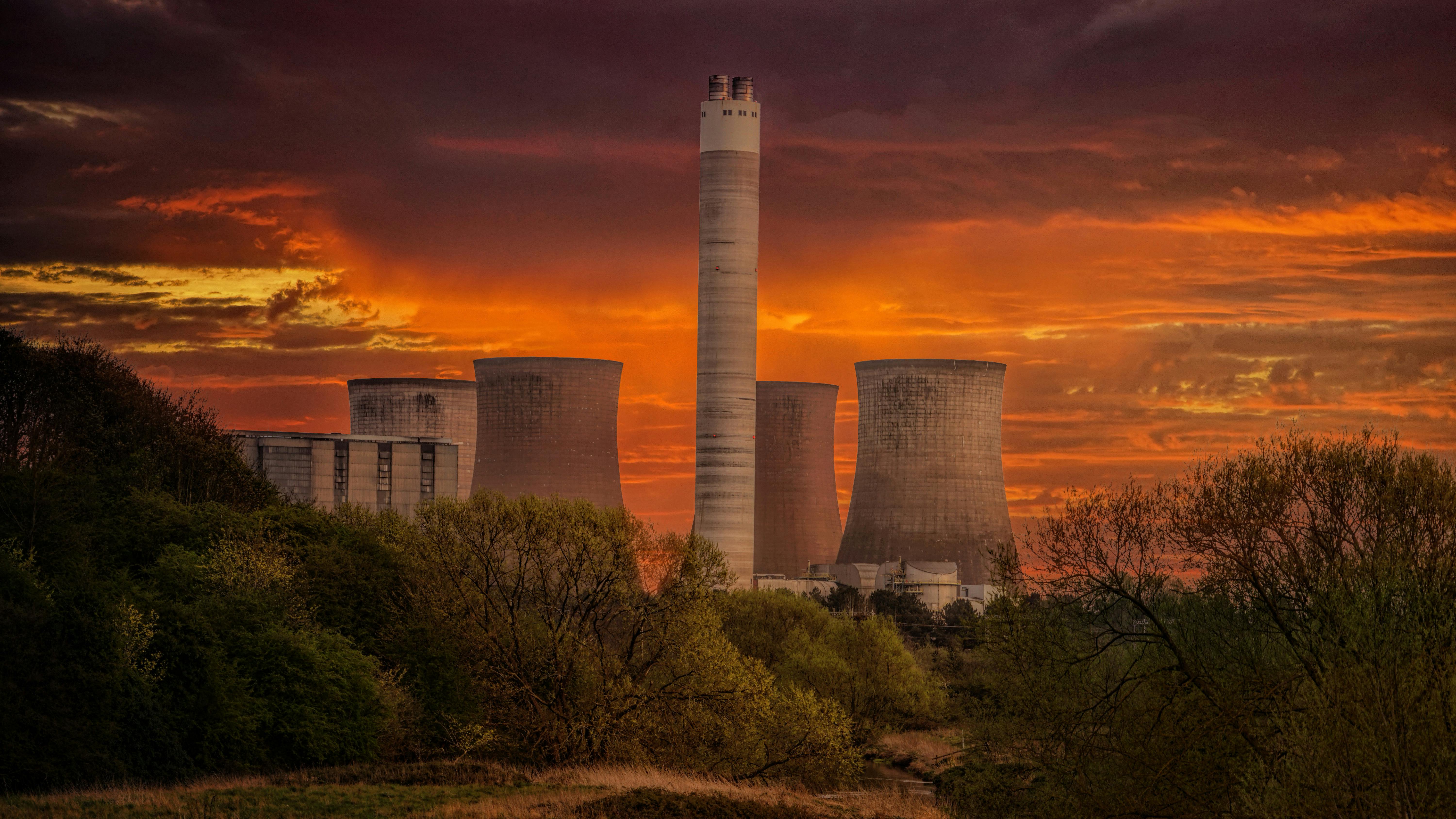 6000x3375 White Nuclear Plant Silo Under Orange Sky at Sunset · Free