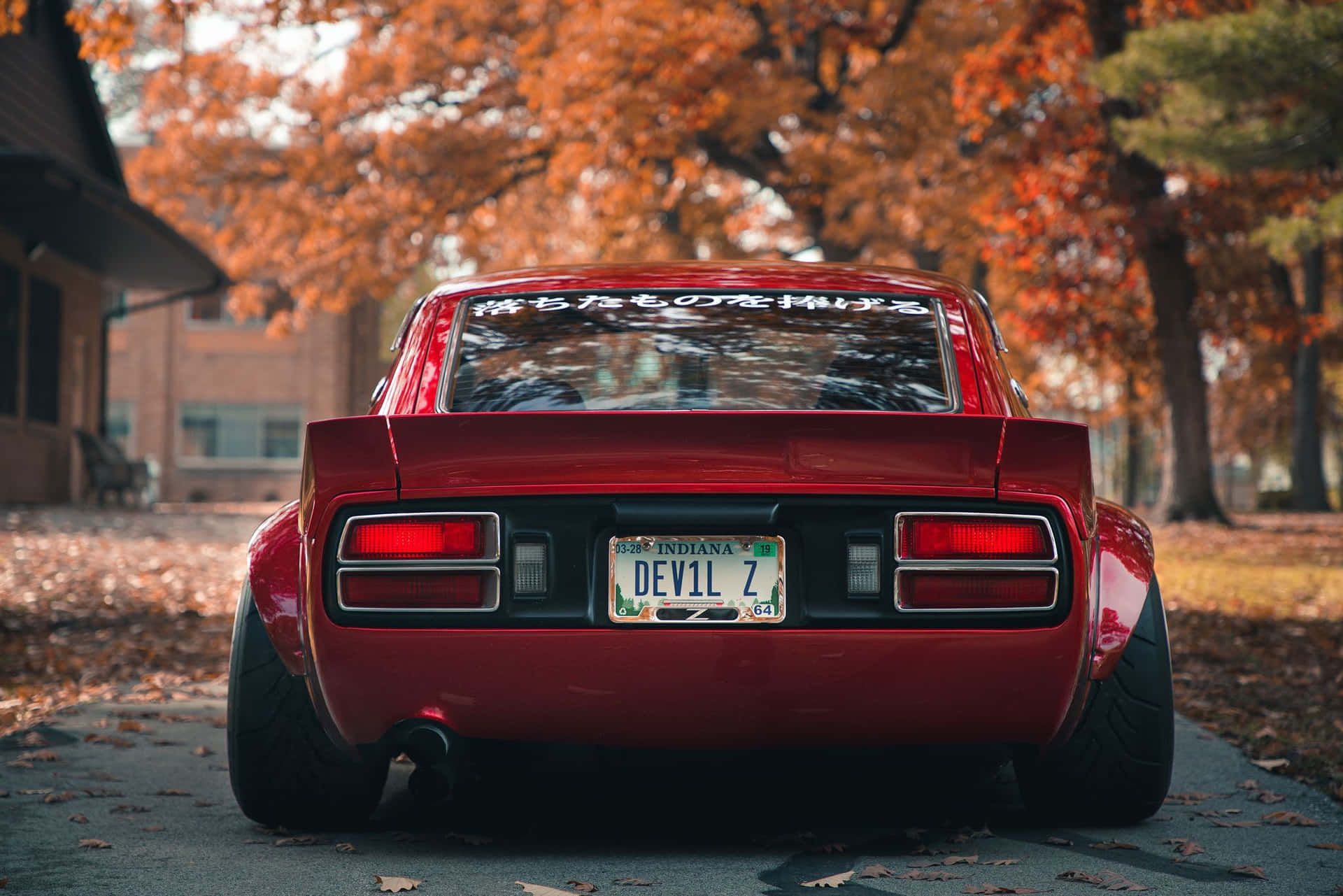 1920x1281 Download Sleek red Datsun car parked on a city street Wallpaper