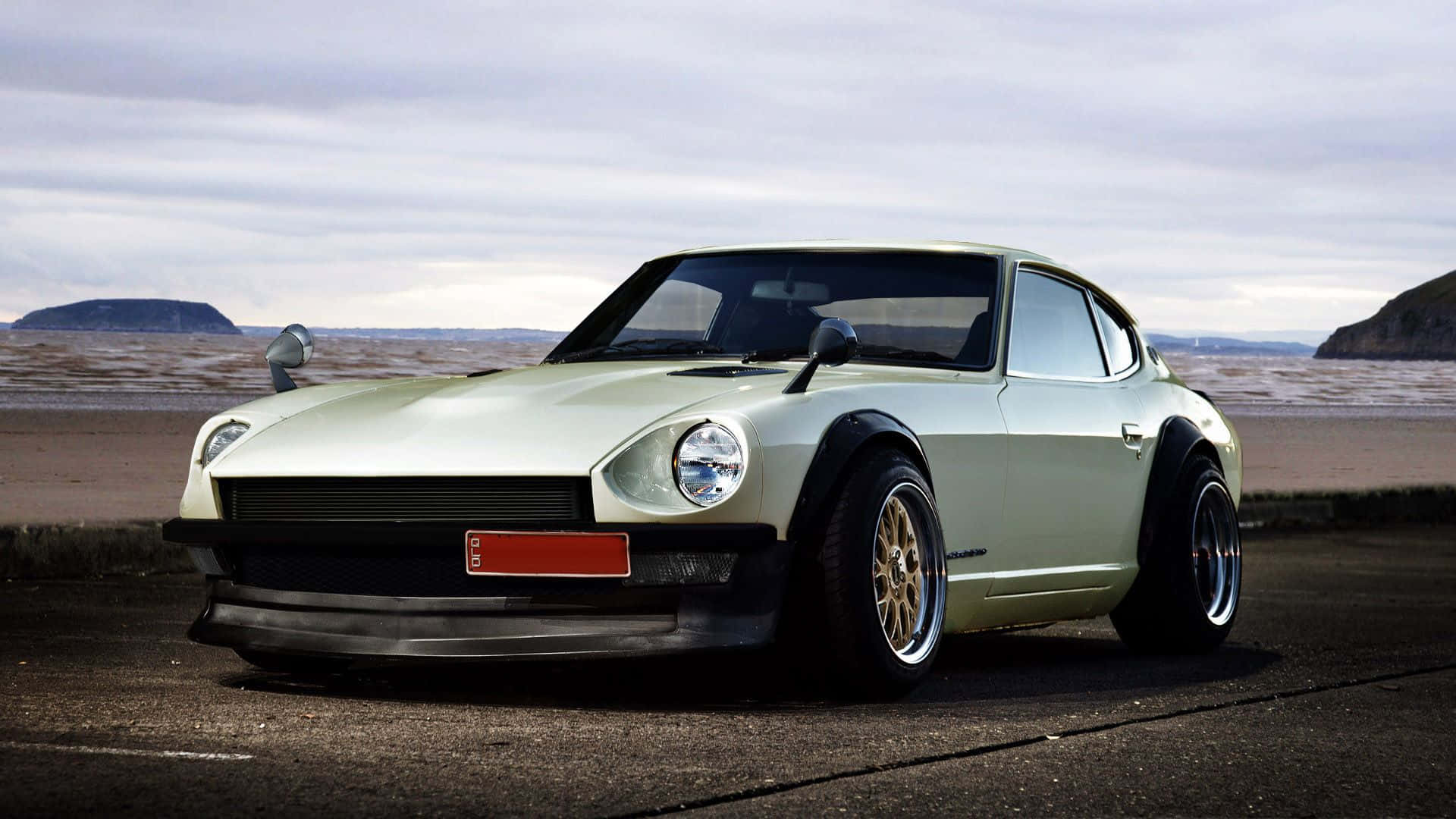 1920x1080 Download Caption: Stunning Datsun Classic Car on Road Wallpaper