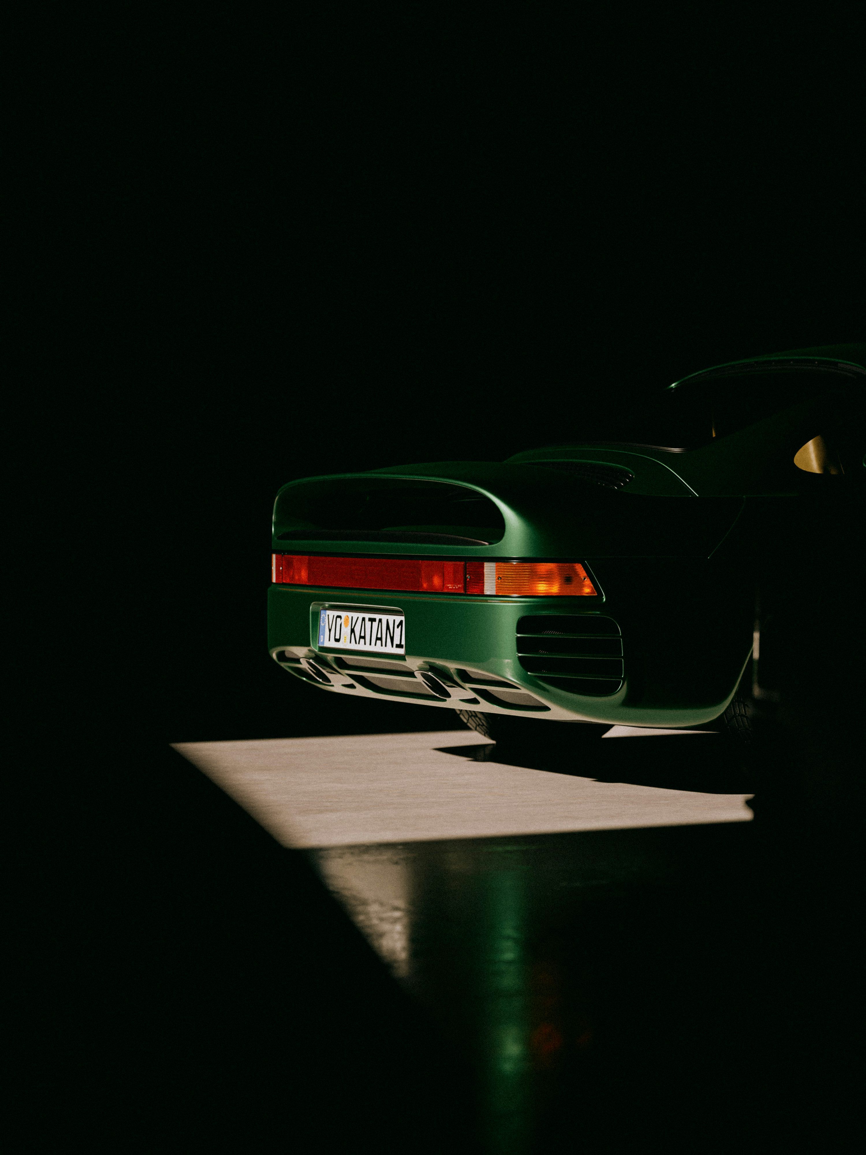 3000x4000 A green sports car parked in the dark photo