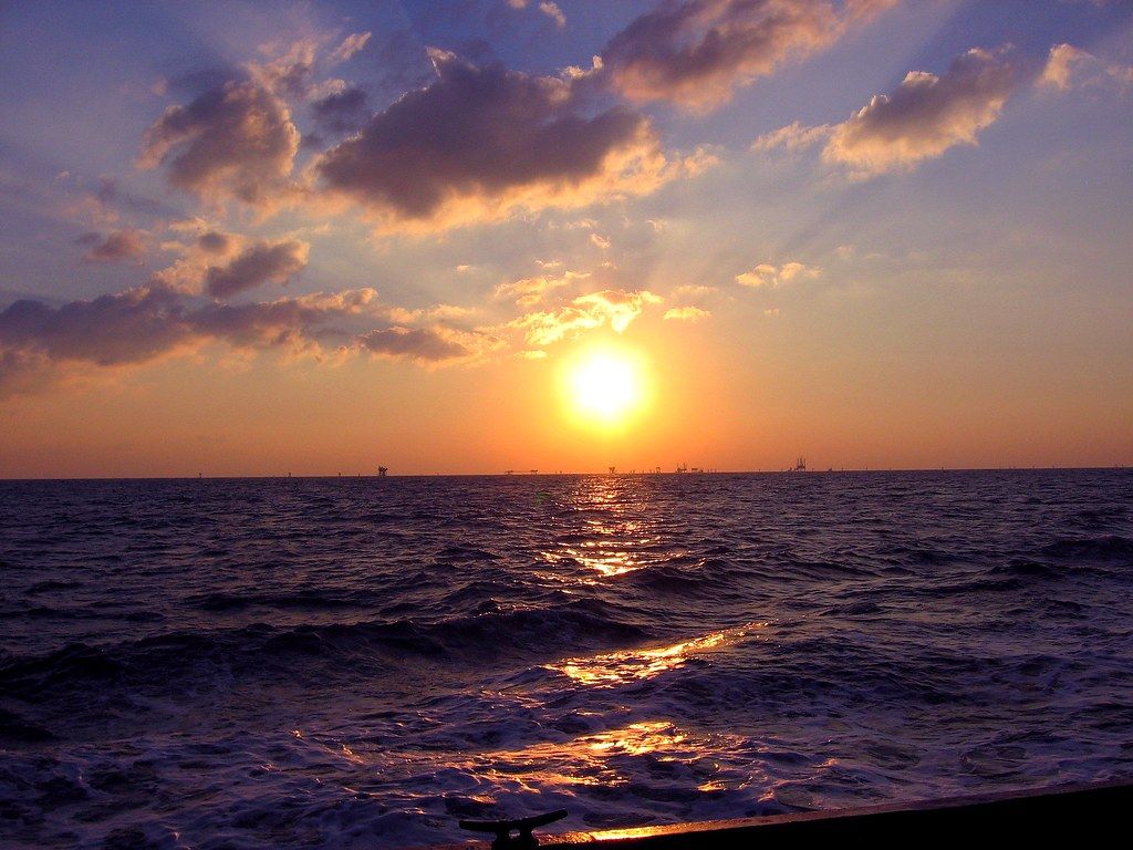 1024x768 Gulf of Mexico Sunset. Rigs dot the skyline in the Gulf
