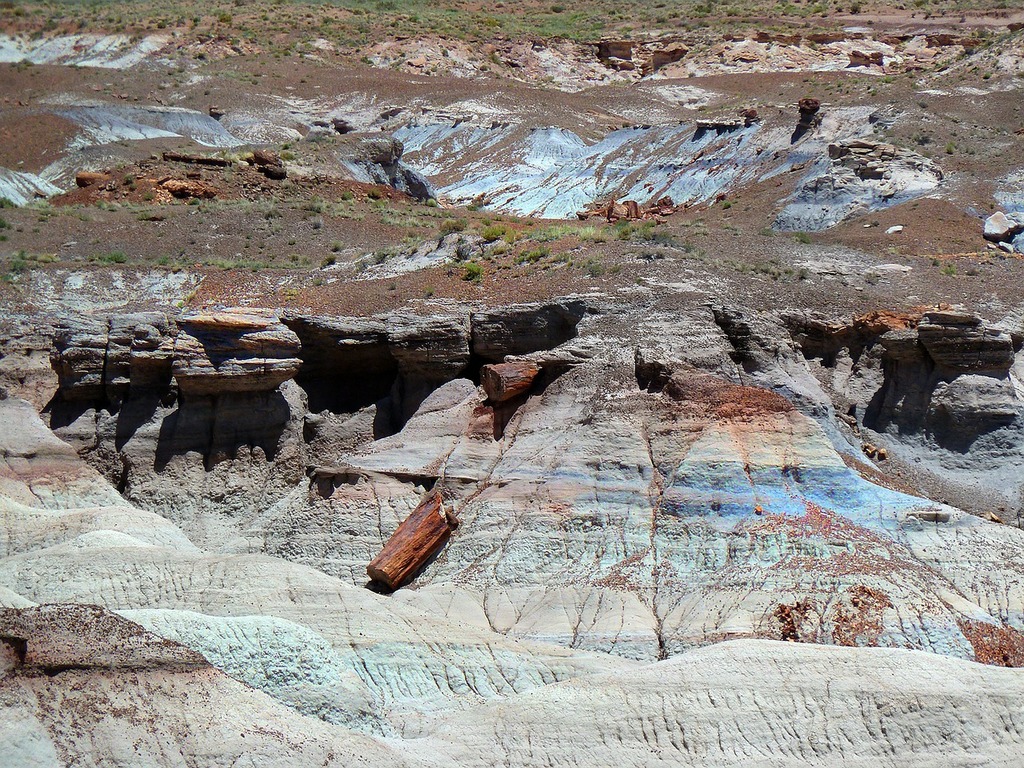 1024x768 A large rock formation in the middle of a desert. Petrified forest national park stony wood colorful. Domain Media Search Engine Public Domain Search