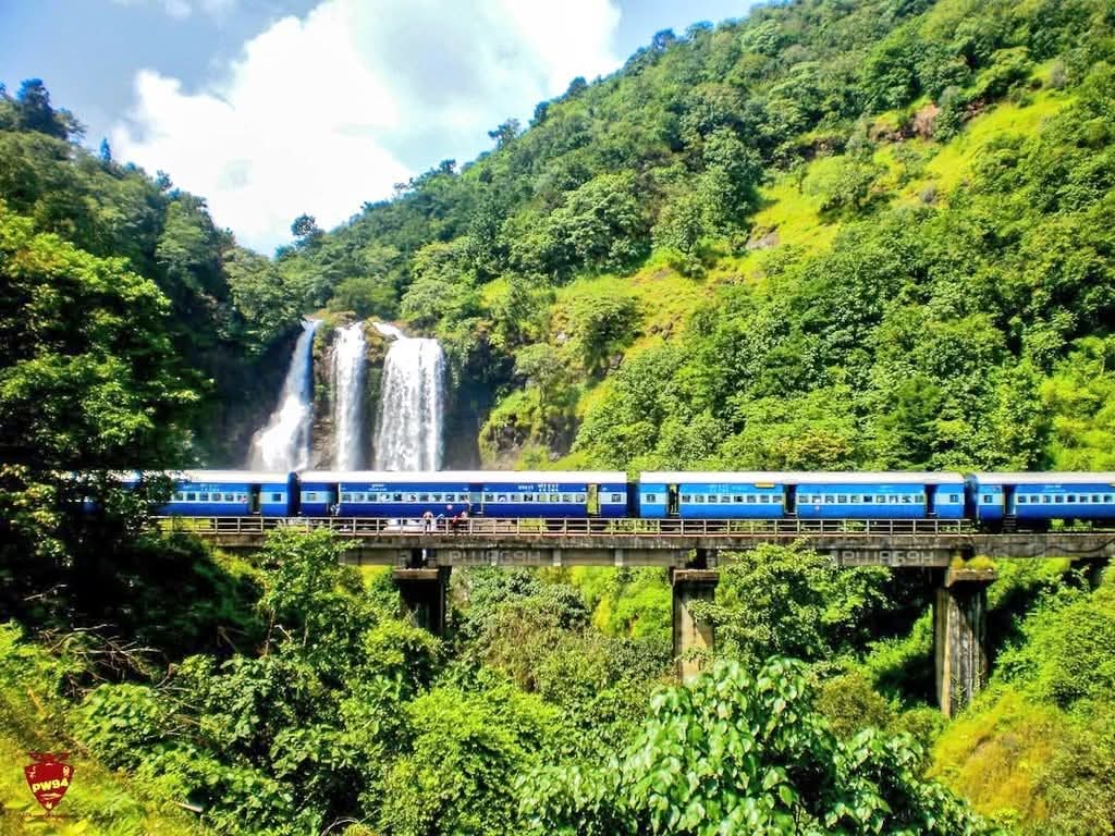 1024x768 Good morning capture of a train passing over the viaduct besides the lovely Ranpat waterfall, surrounded by the lush greenery of the Sahyadris the magnificent Konkan Railway Route