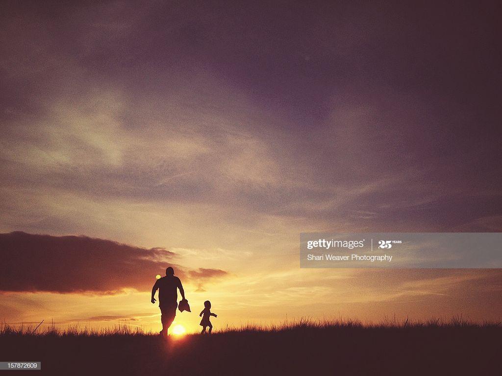 1024x768 Father And Daughter Running Up Hill At Sunset High Res