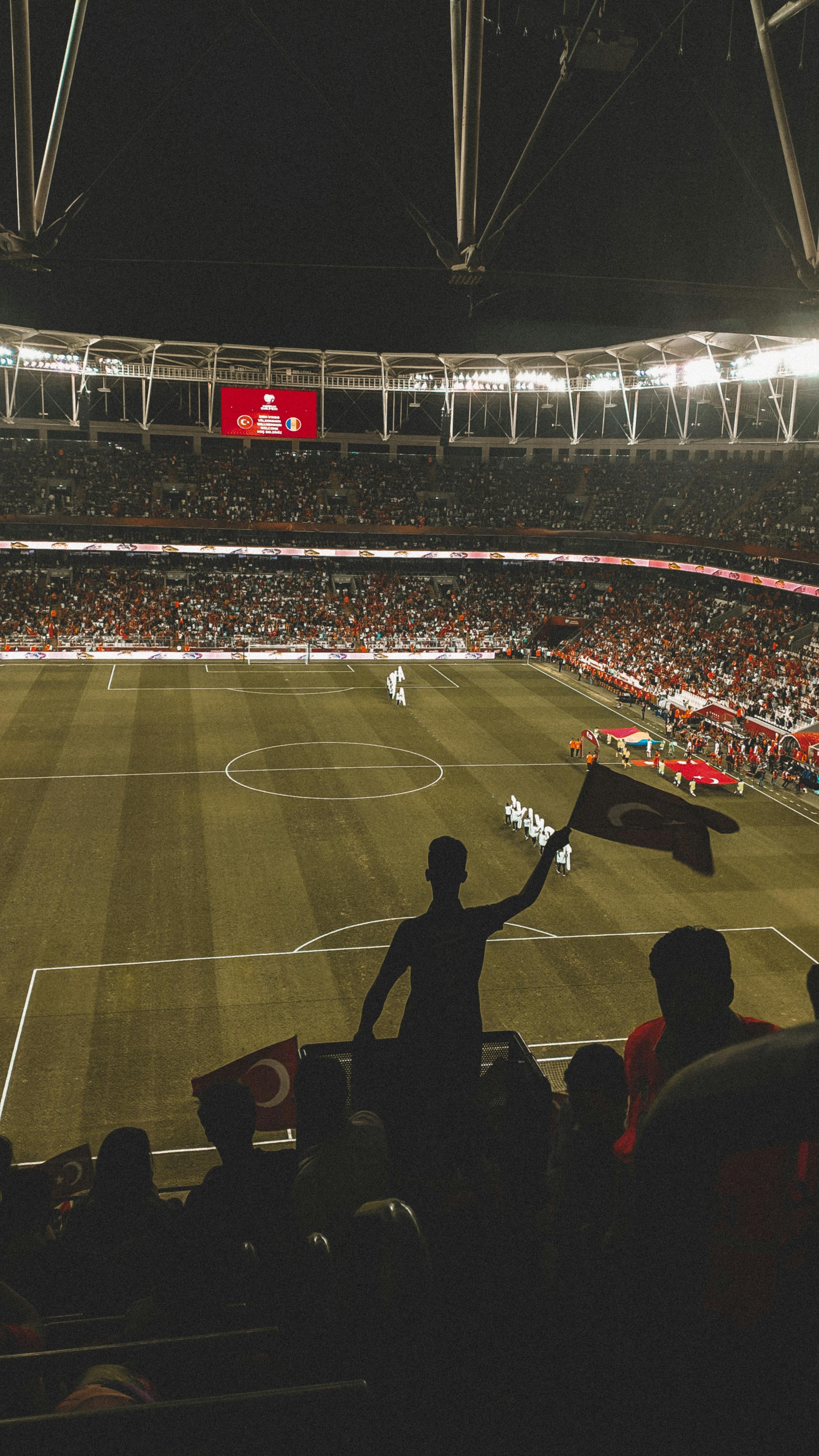 2268x4032 Fans sitting on tribunes in football stadium · Free