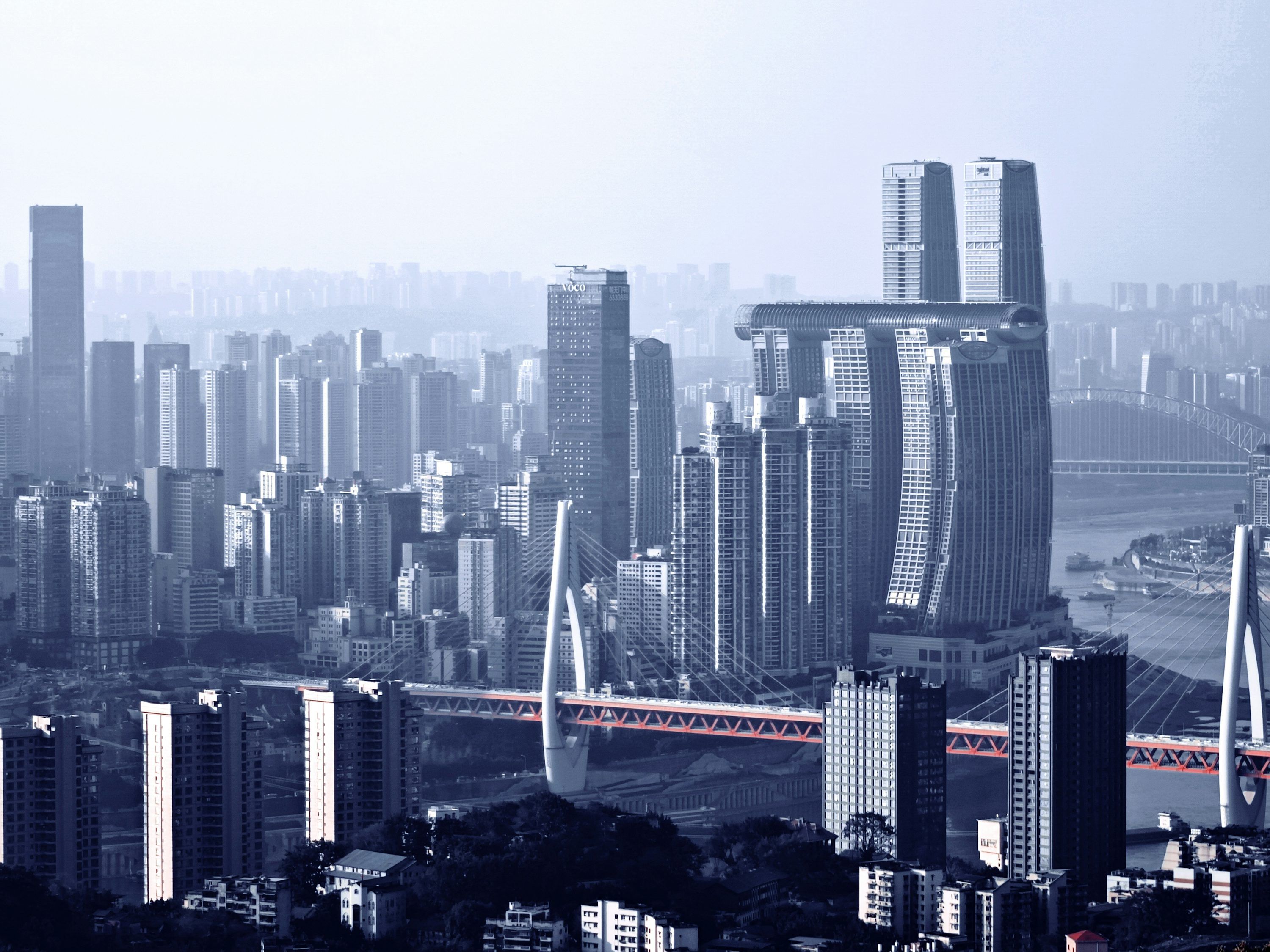 3000x2250 A view of a city with a bridge in the foreground photo