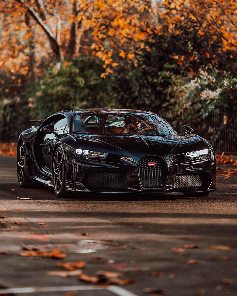 800x1000 Bugatti by dappled light filteringsh green trees, the black carbon bodywork of the CHIRON Super Sport reveals its secrets of performance. #BUGATTI #BUGATTIChiron #CHIRONSuperSport