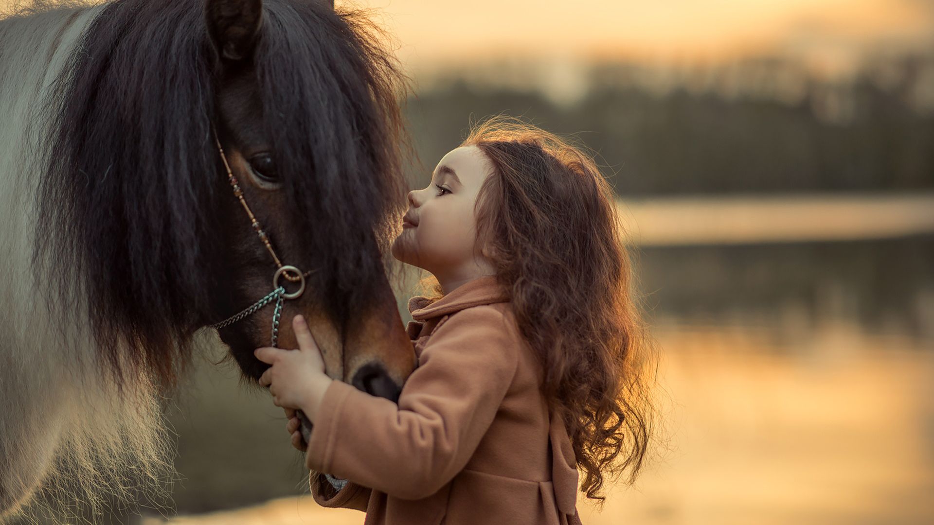 1920x1080 Cute Little Girl Is Playing With Horse Wearing Brown Dress In Blur Background HD Cute Wallpaper