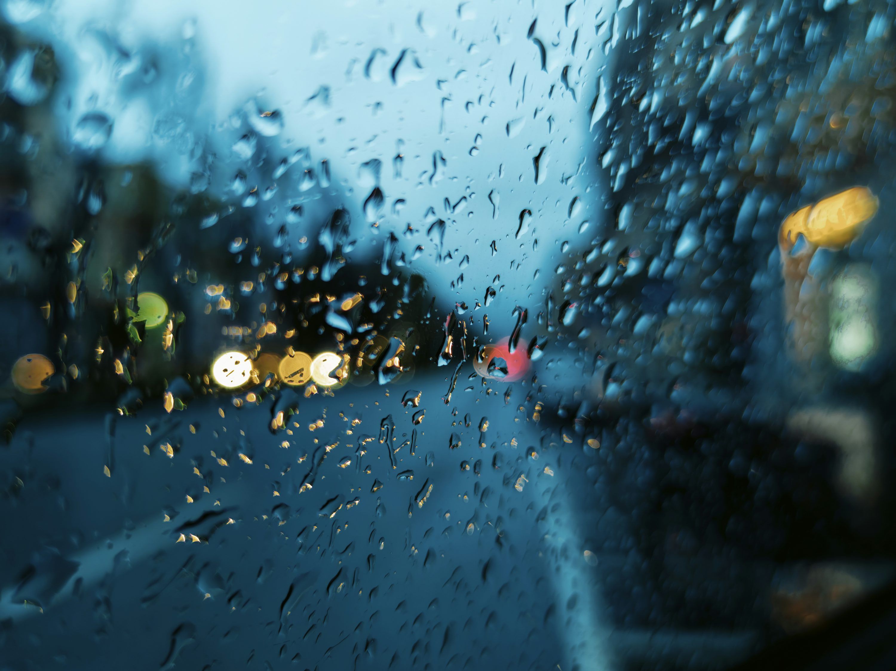 3000x2248 A view of a street through a rain covered window photo