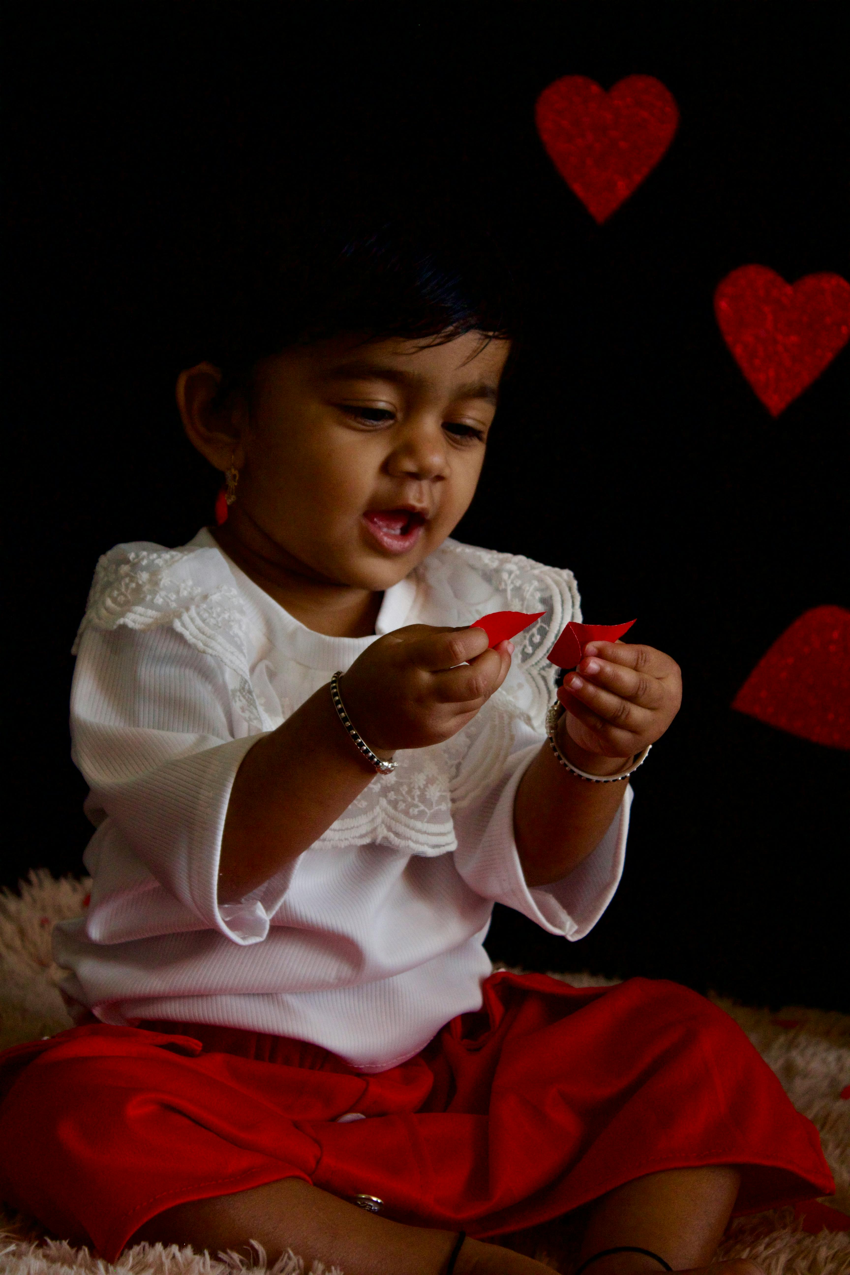 3456x5184 Girl Sitting and Holding Paper Hearts · Free