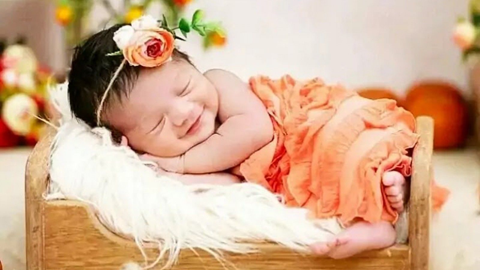 1600x900 Smiling Cute Baby Girl Child Is Sleeping On Little Bed Wearing Light Orange Dress HD Cute Wallpaper